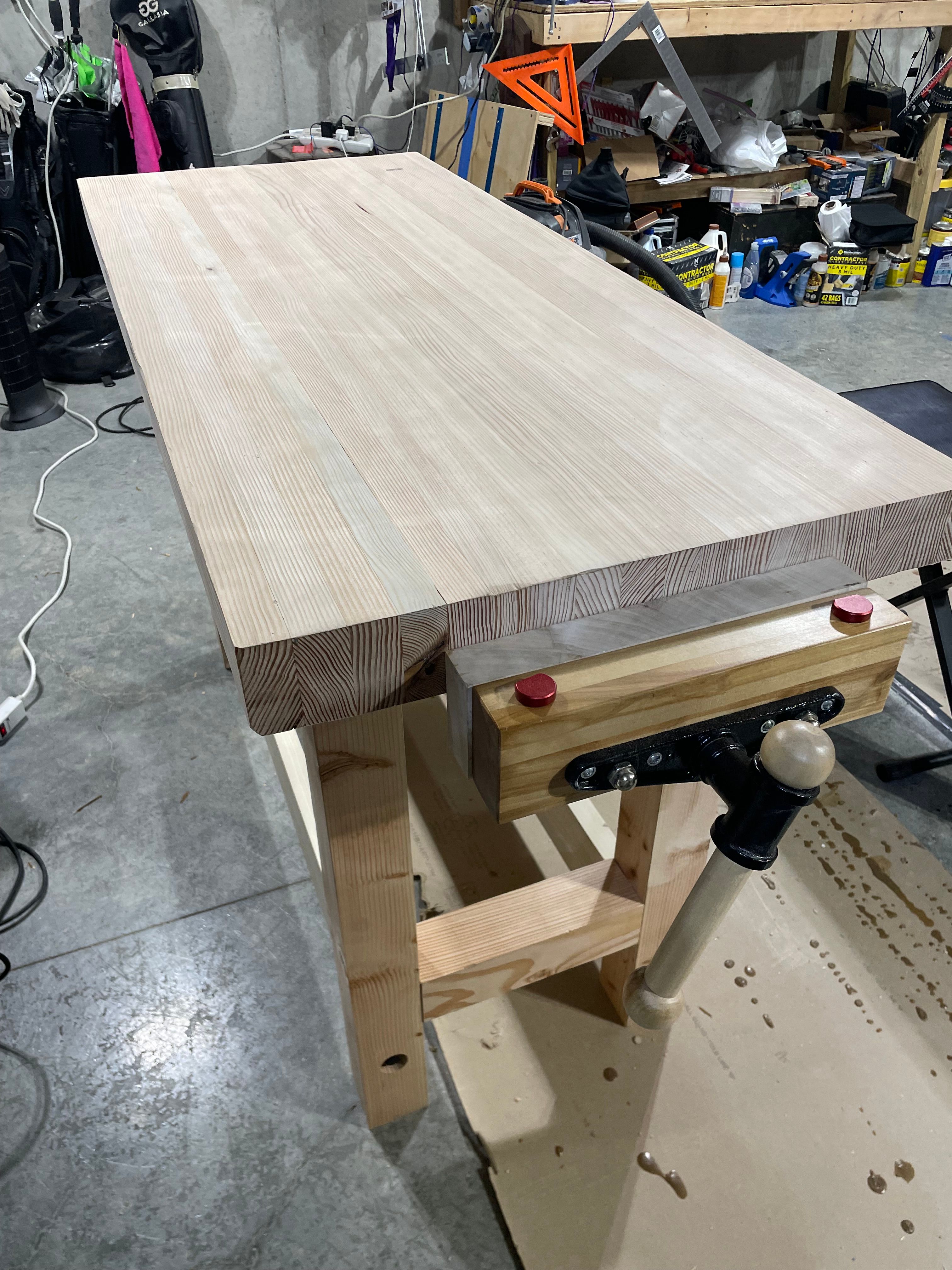 Custom workbench with wooden vise and metal clamp mechanism