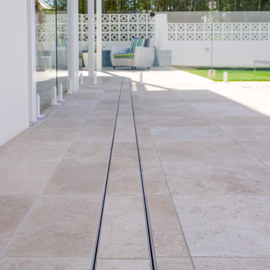 Finished patio with a linear drainage system through the tile