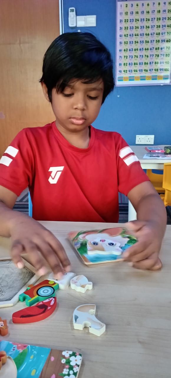 Child playing with wooden puzzle