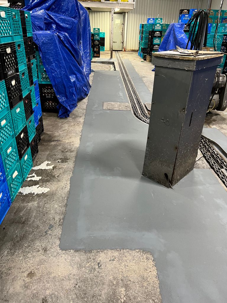 Floor repair in food and beverage production area with metal track system