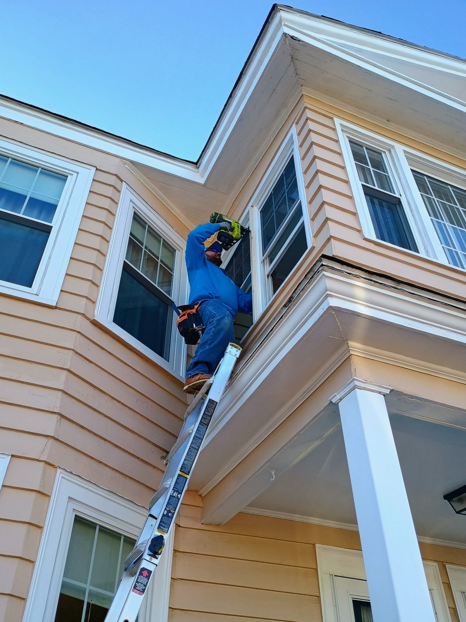 Task Masters Home Services working on exterior trim
