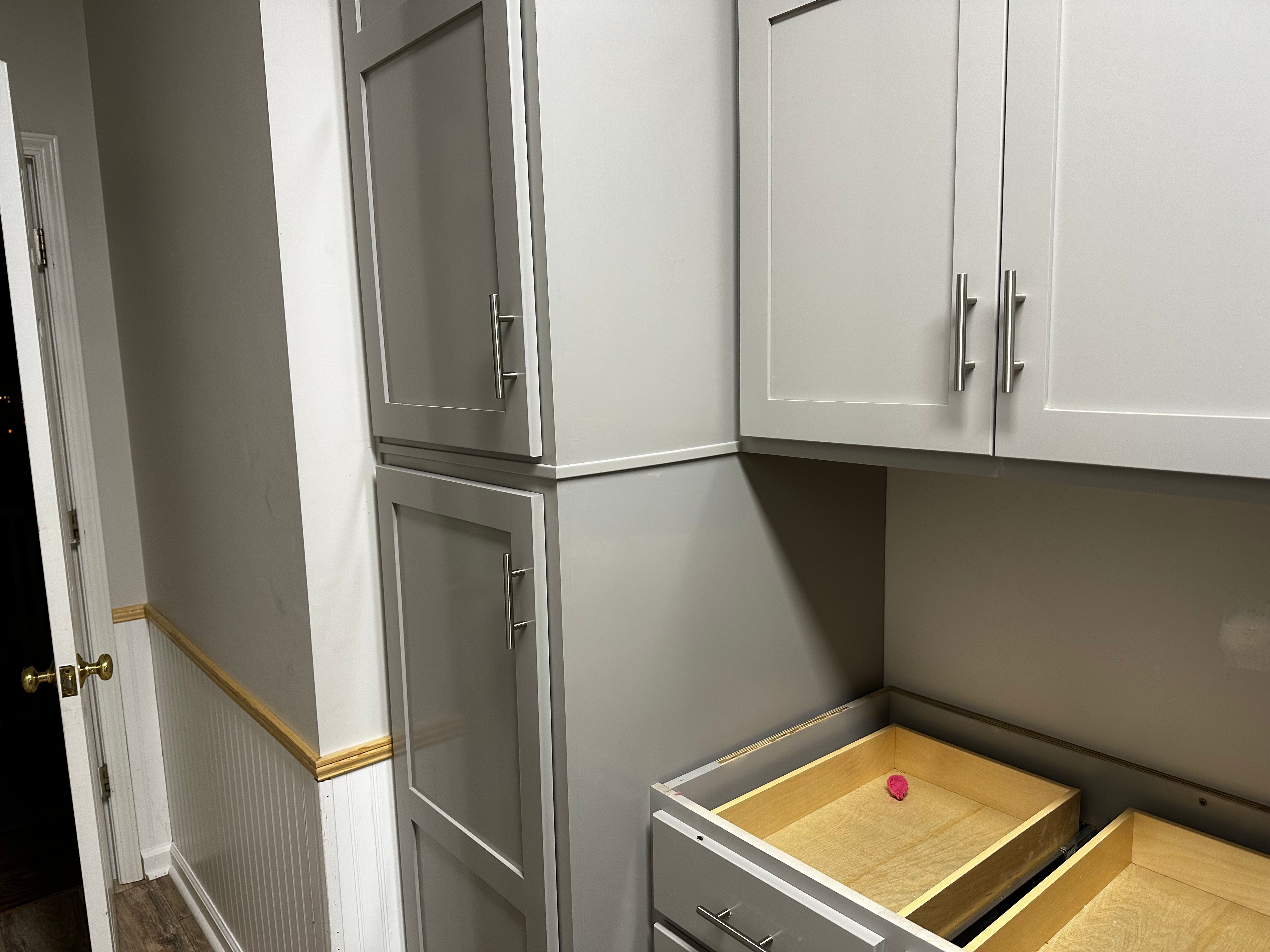 Custom gray utility cabinets with pull-out drawer trays