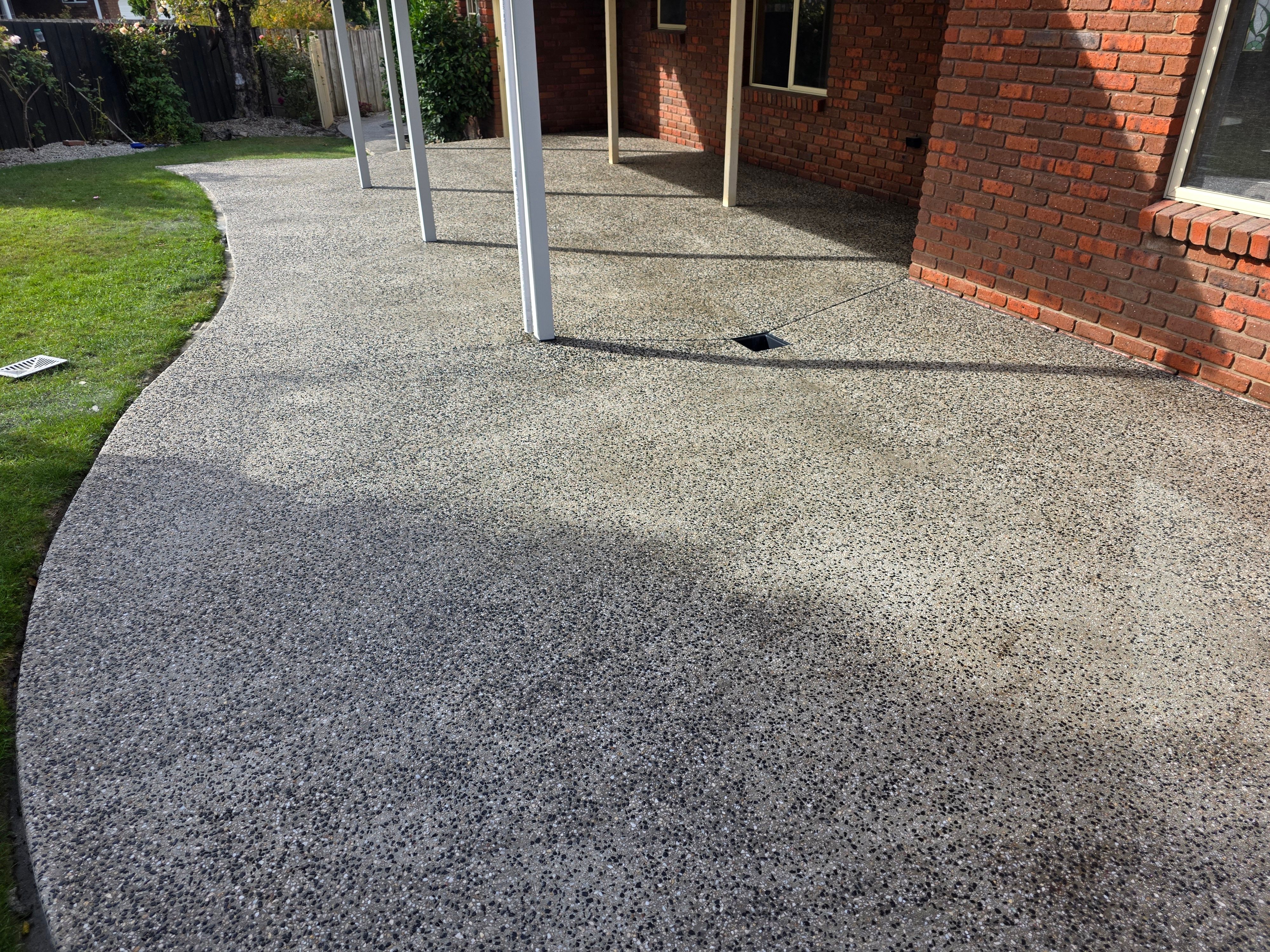 Curved exposed aggregate patio area