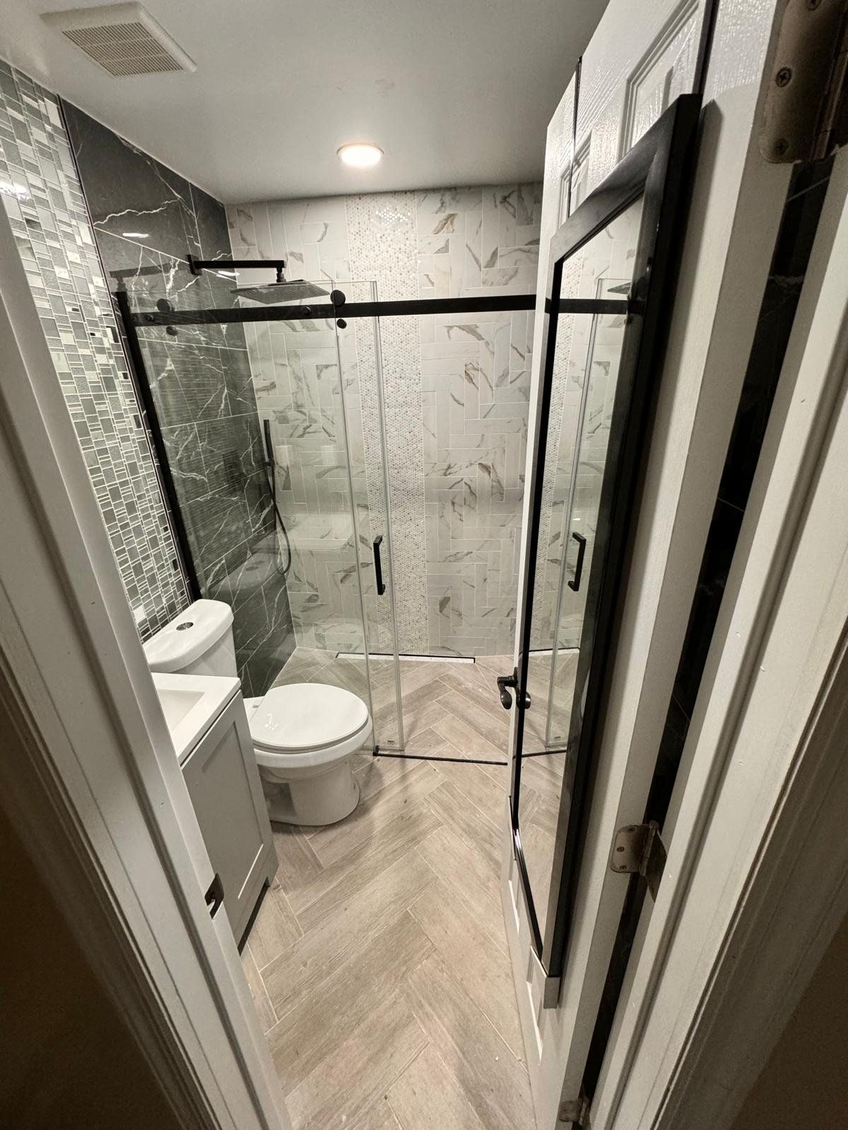 Complete bathroom remodel with glass shower door
