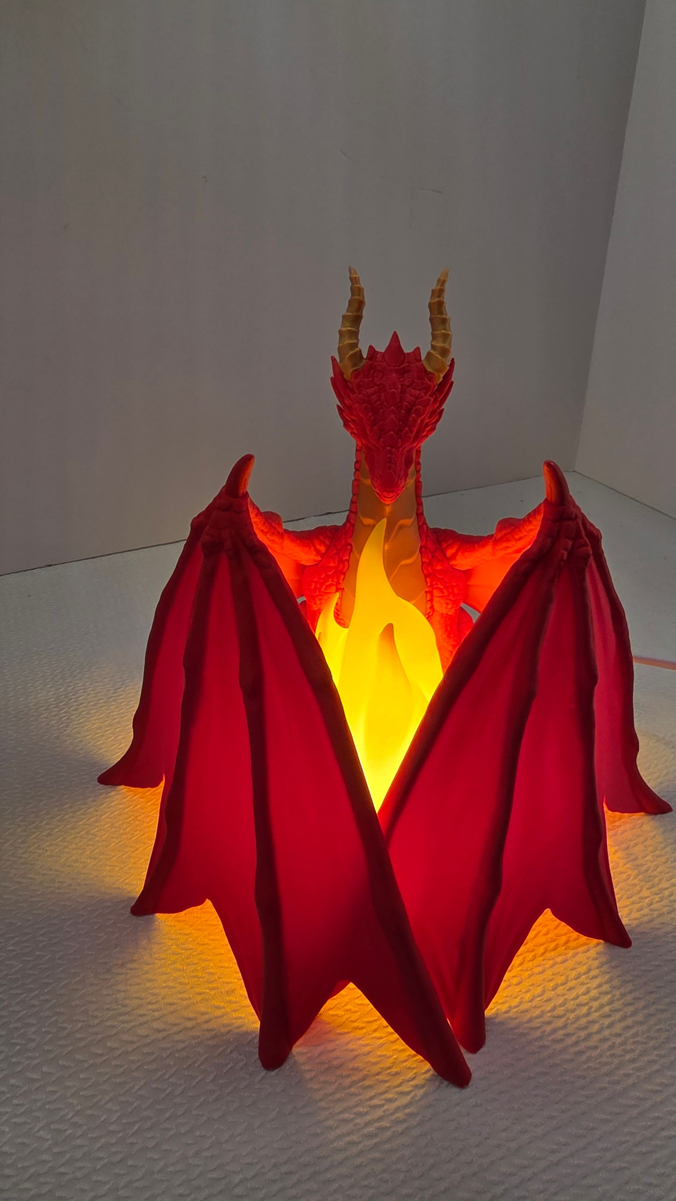 Red dragon with wings spread and flame