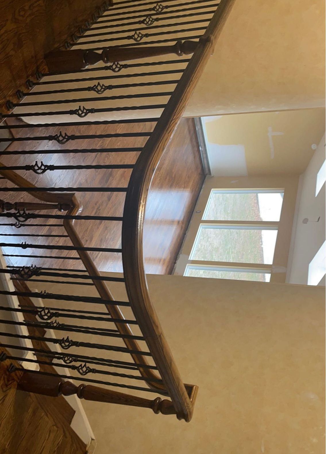 Staircase with refinished hardwood and metal balusters in Rockford IL