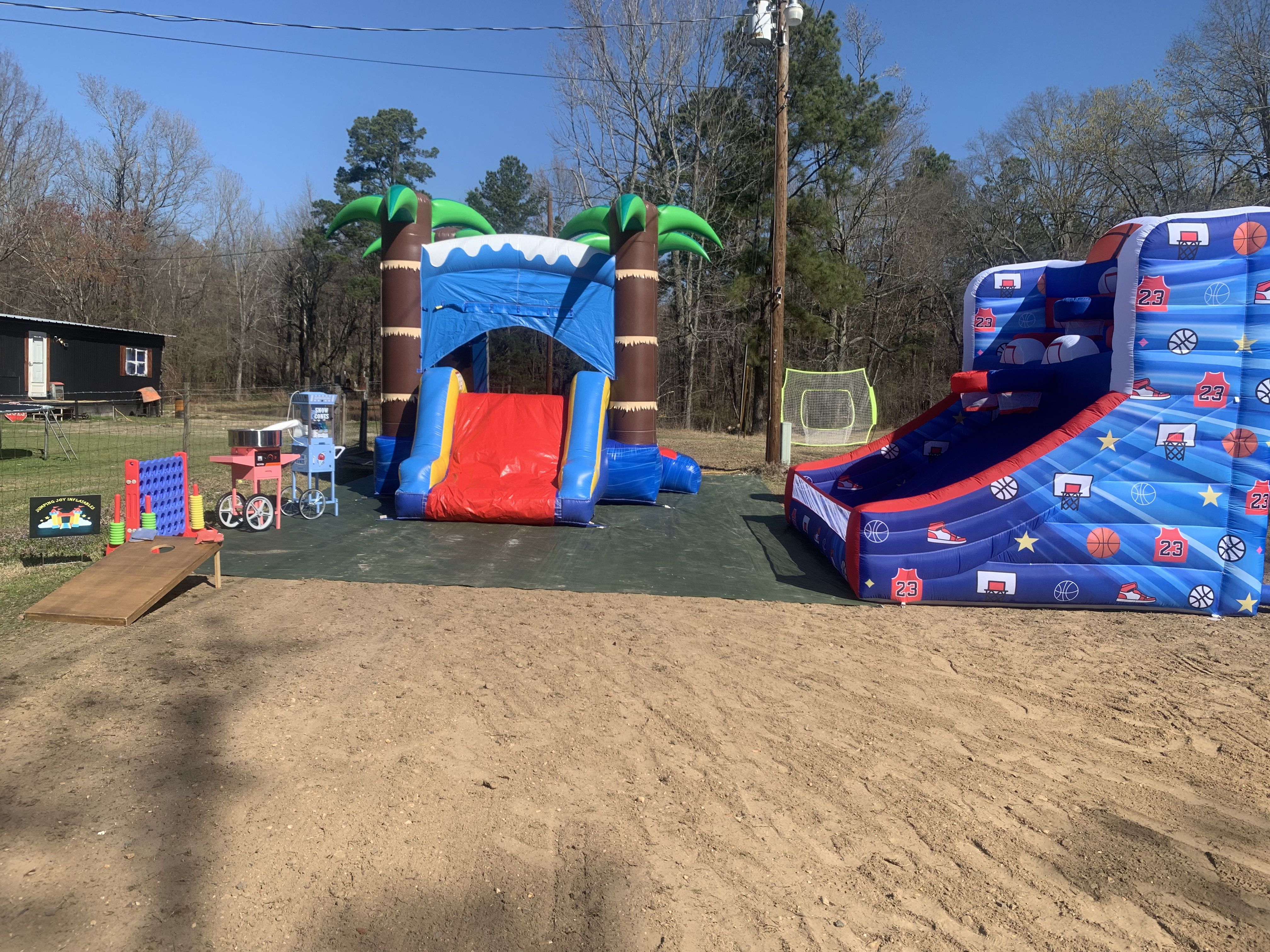 Ultimate Celebration setup with inflatables, concessions, and yard games