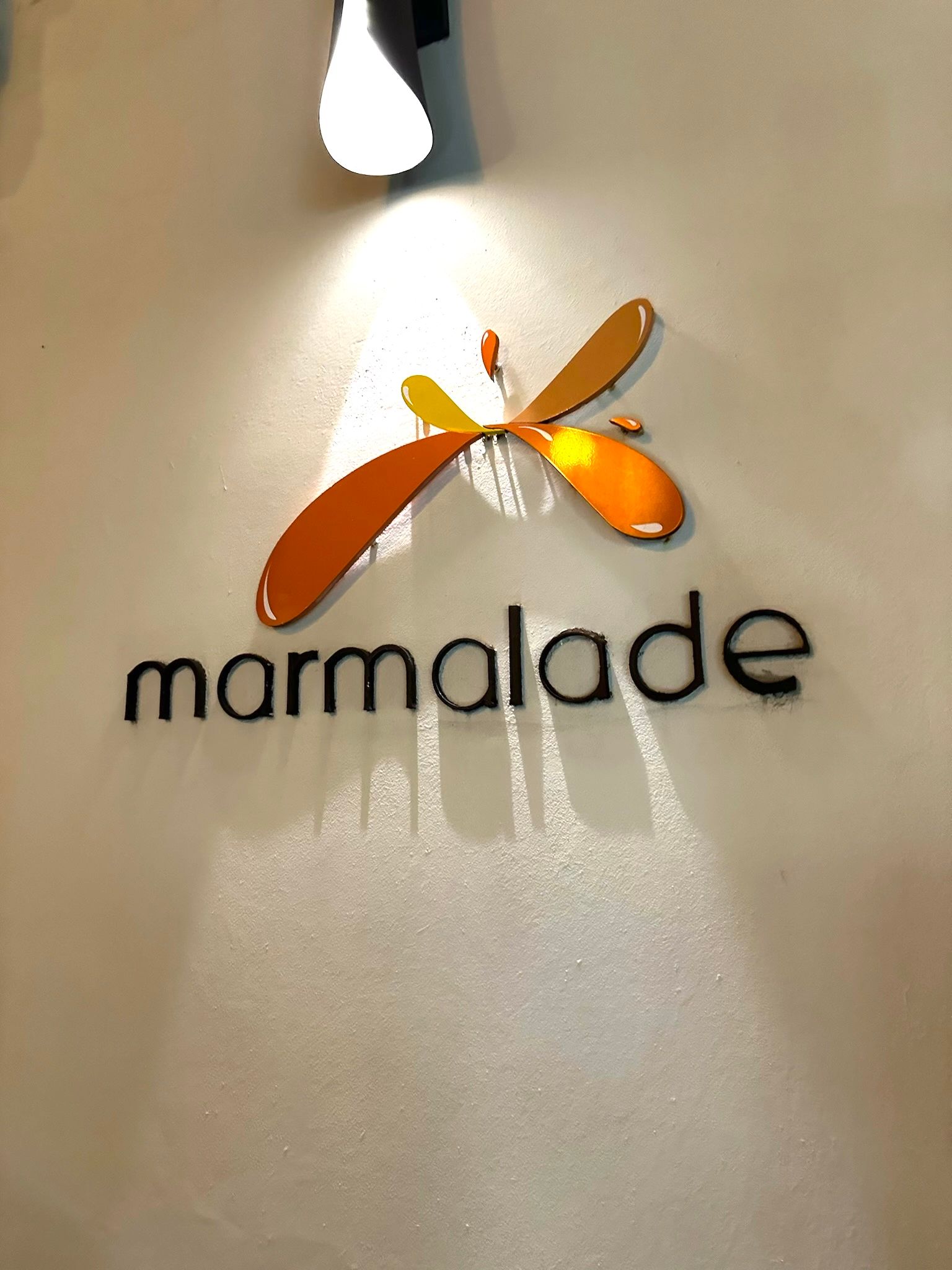 Marmalade Restaurant & Wine Bar — the iconic 'marmalade' sign with orange and yellow logo on the wall, Old San Juan, Puerto Rico