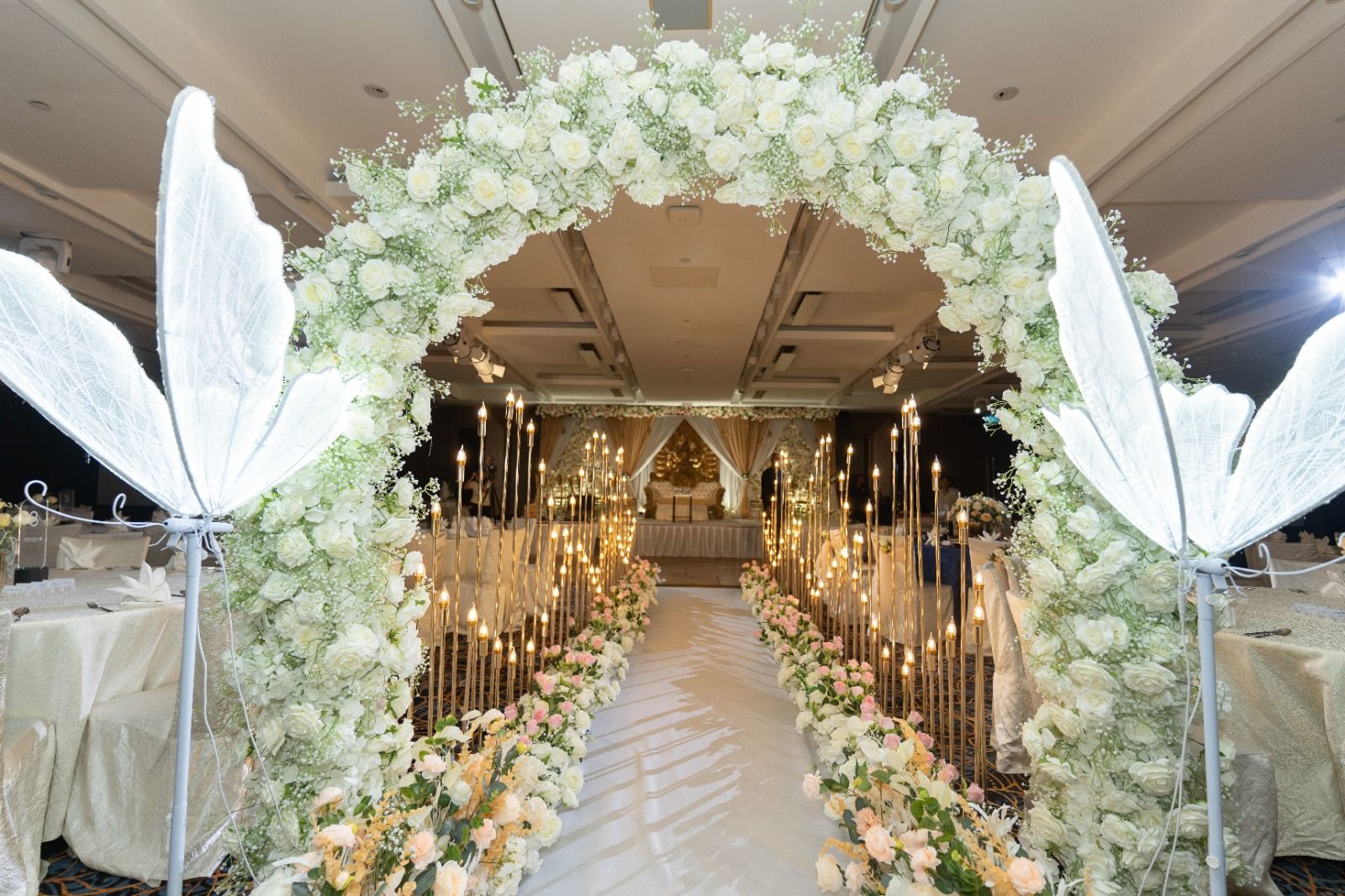 Ballroom wedding setup with floral aisle