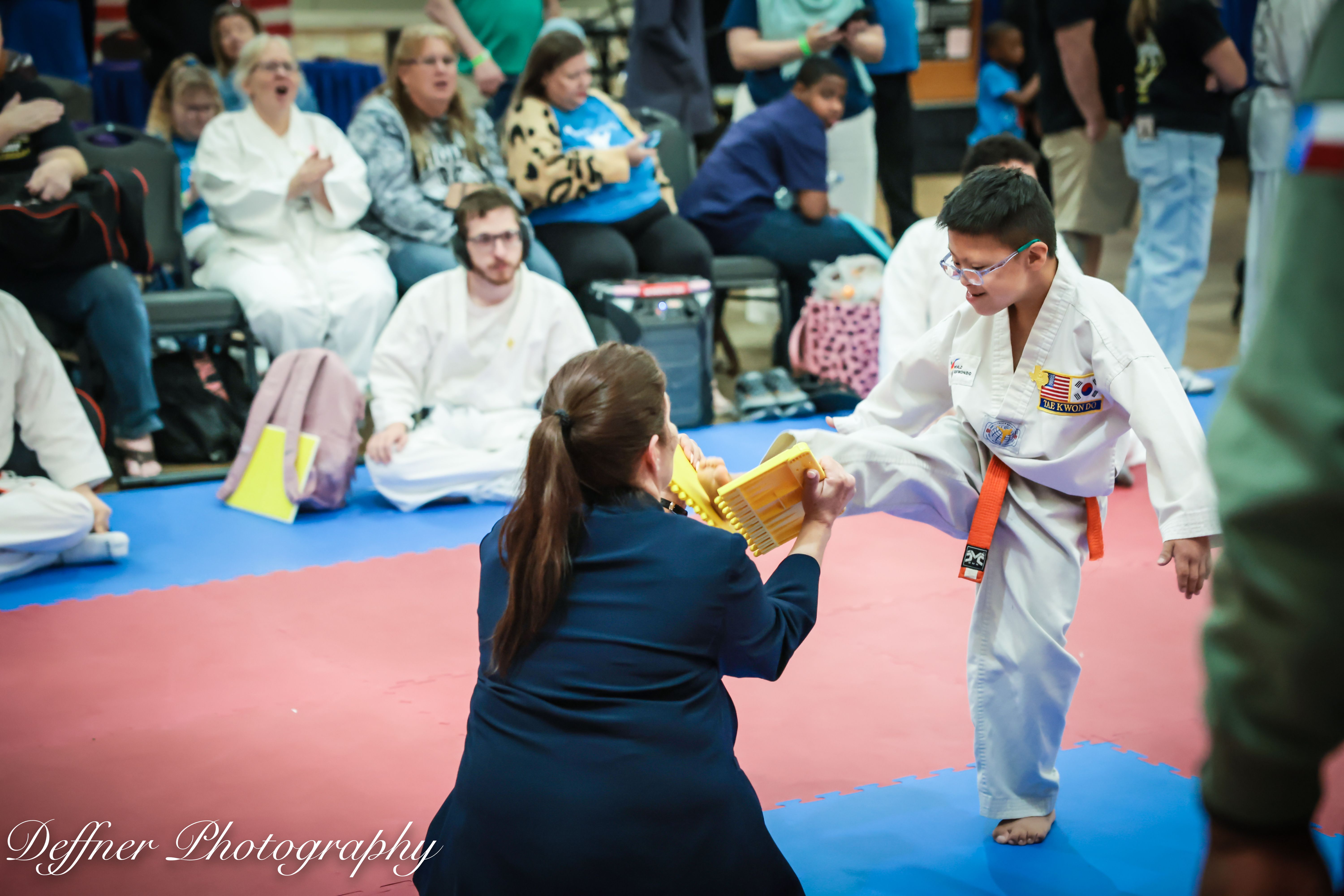 Young student performing board break at Cox Martial Arts