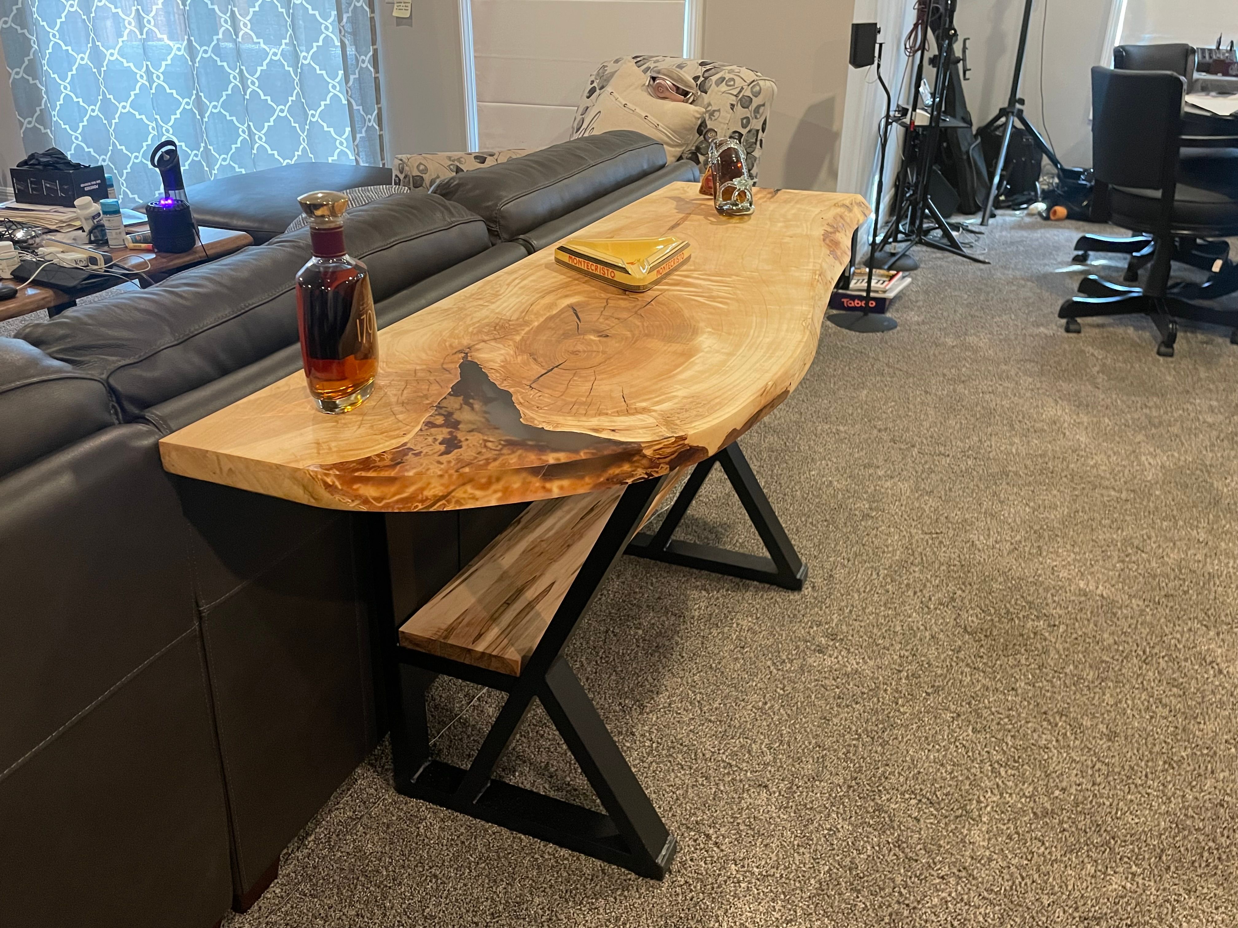 Live edge sofa table behind leather couch in living room