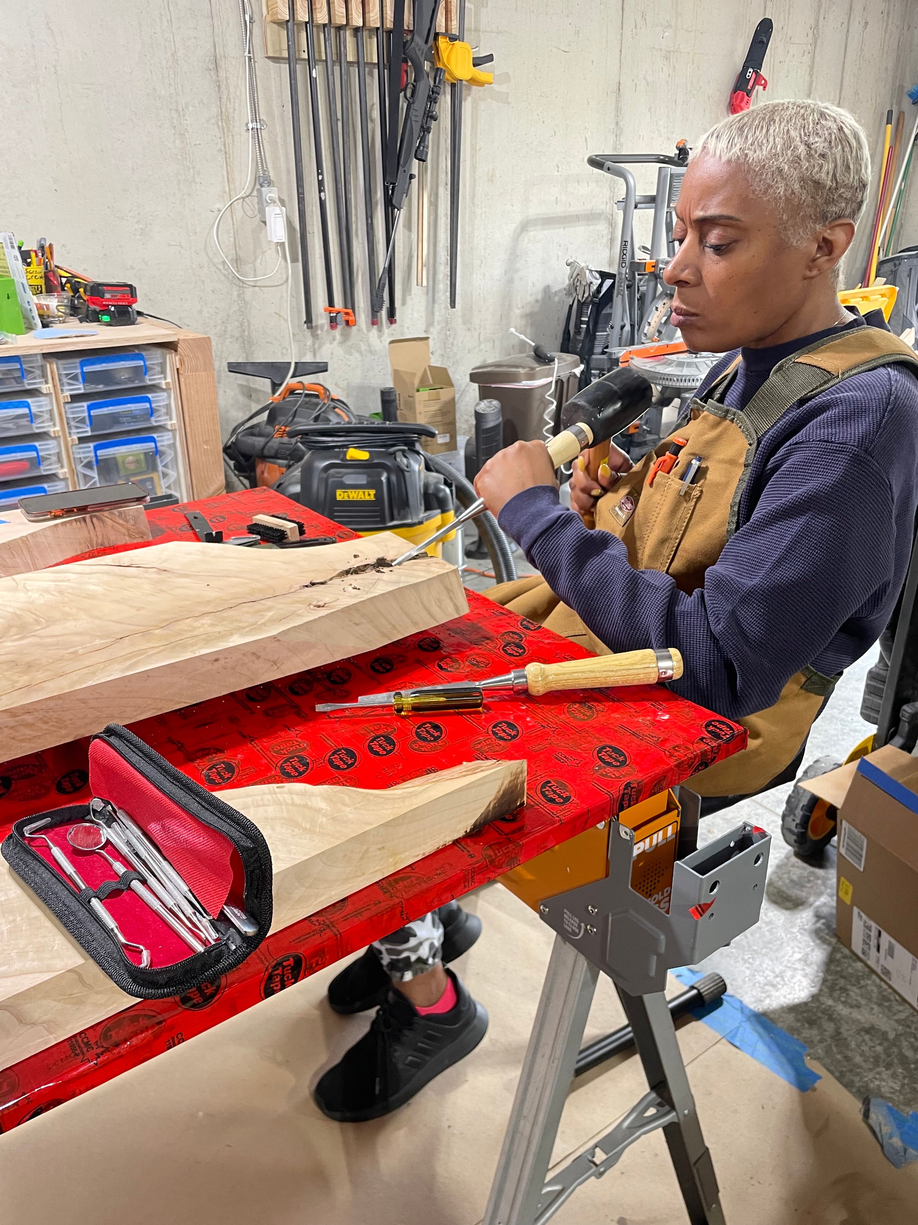 Craftsman chiseling wood at the workbench