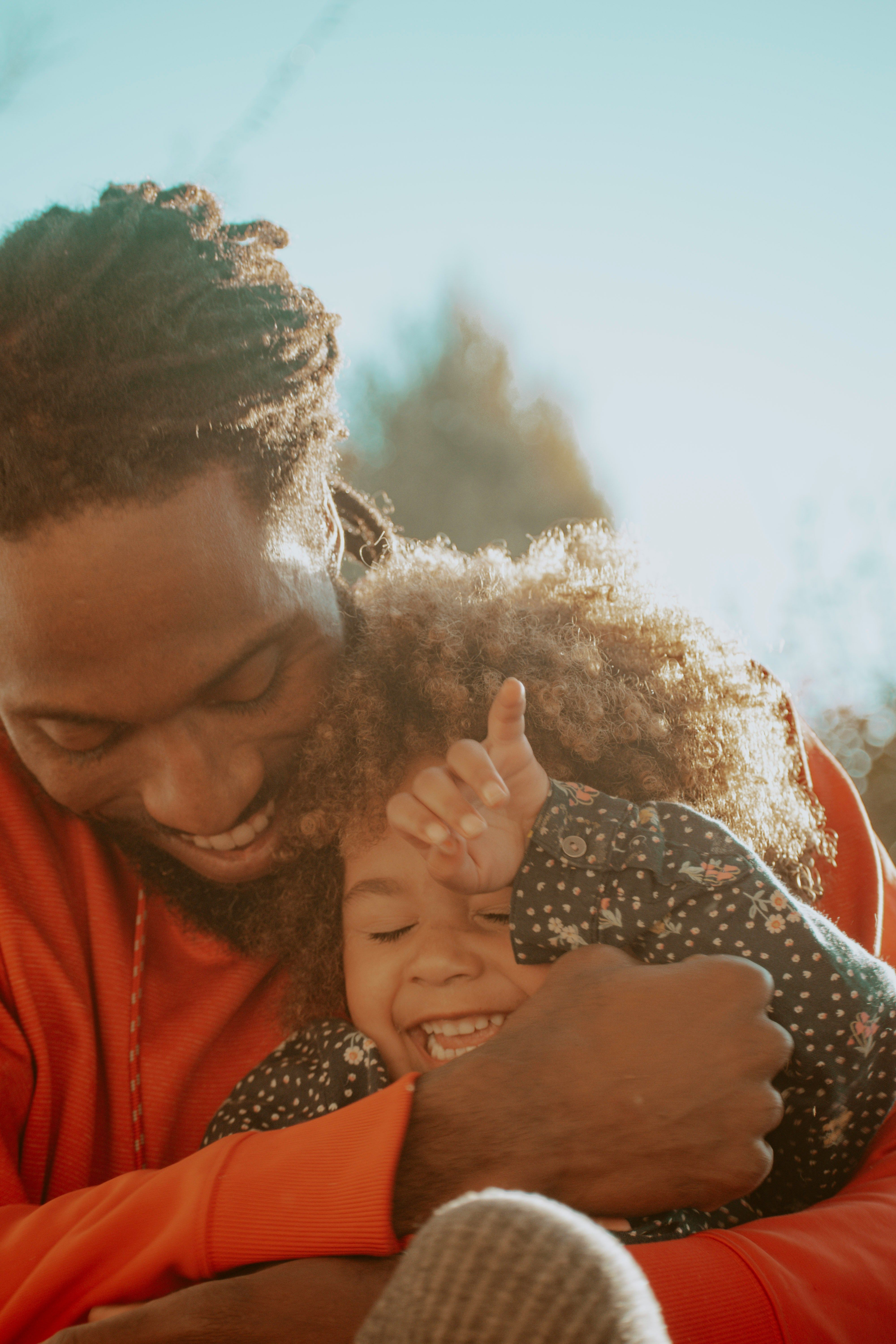 Parent and child sharing a warm embrace outdoors