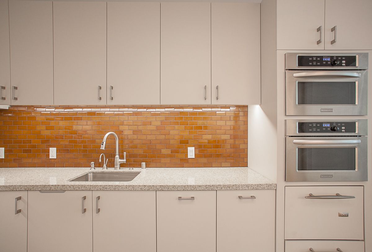 Medical office kitchen cabinetry with countertops and tile backsplash in Pasadena CA healthcare facility