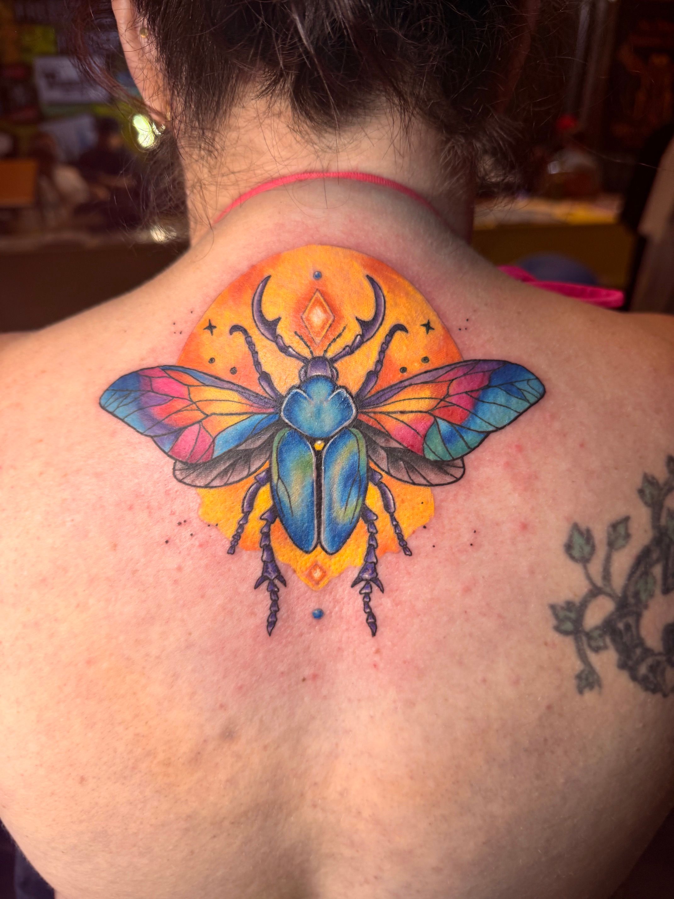 Color tattoo by Justin - blue beetle with sunburst background