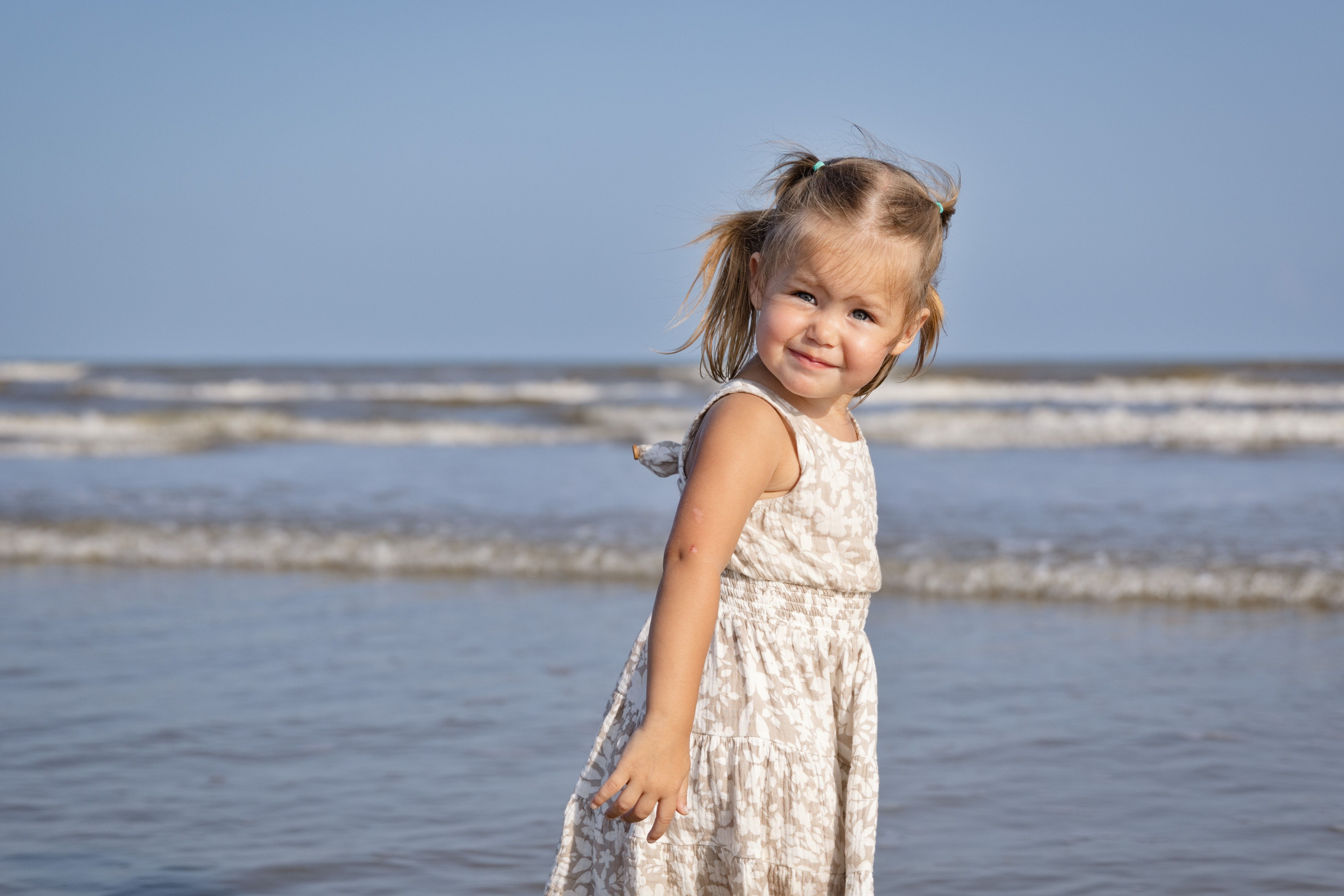 Little girl wading in the ocean shallows