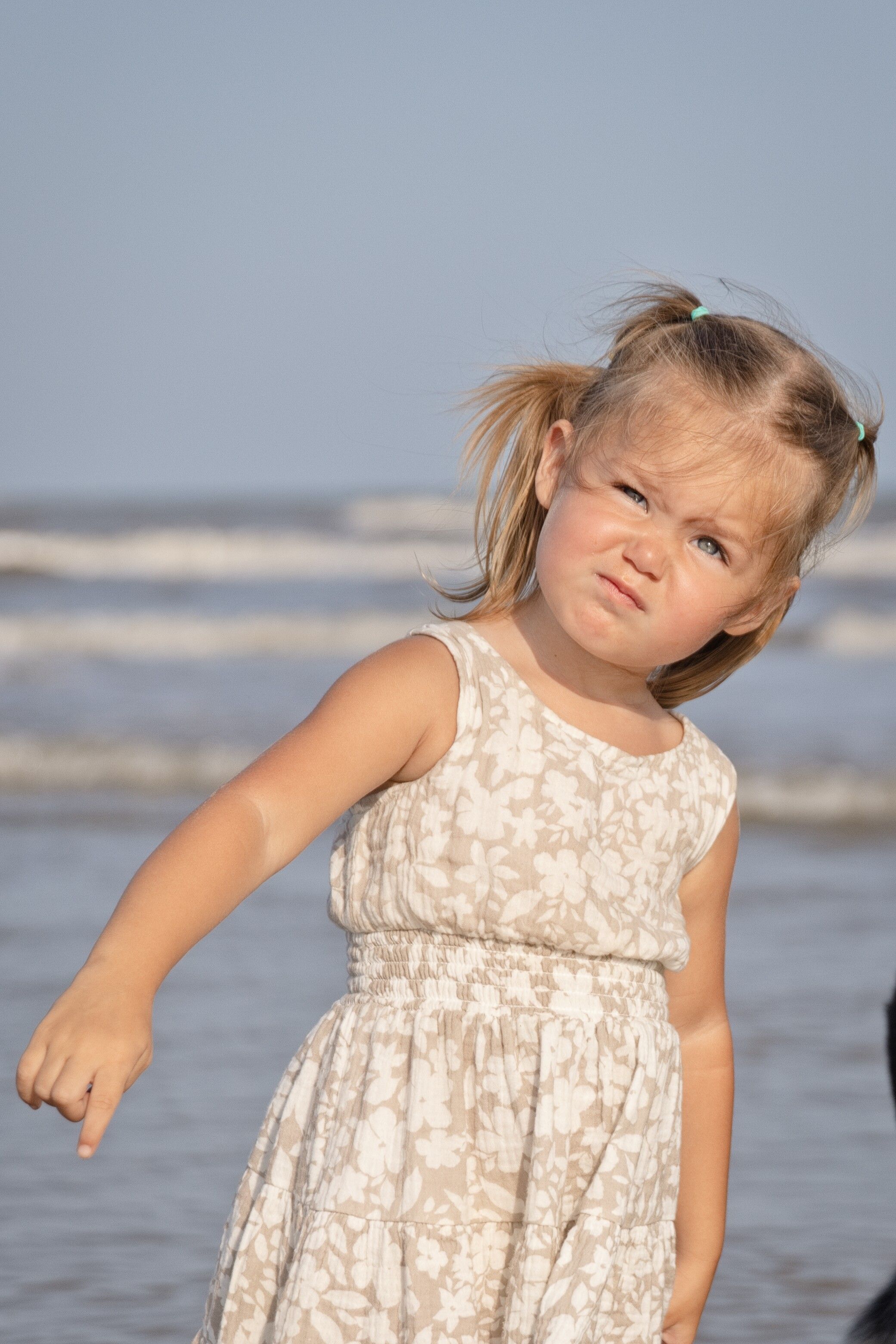 Little girl making a funny face on the beach