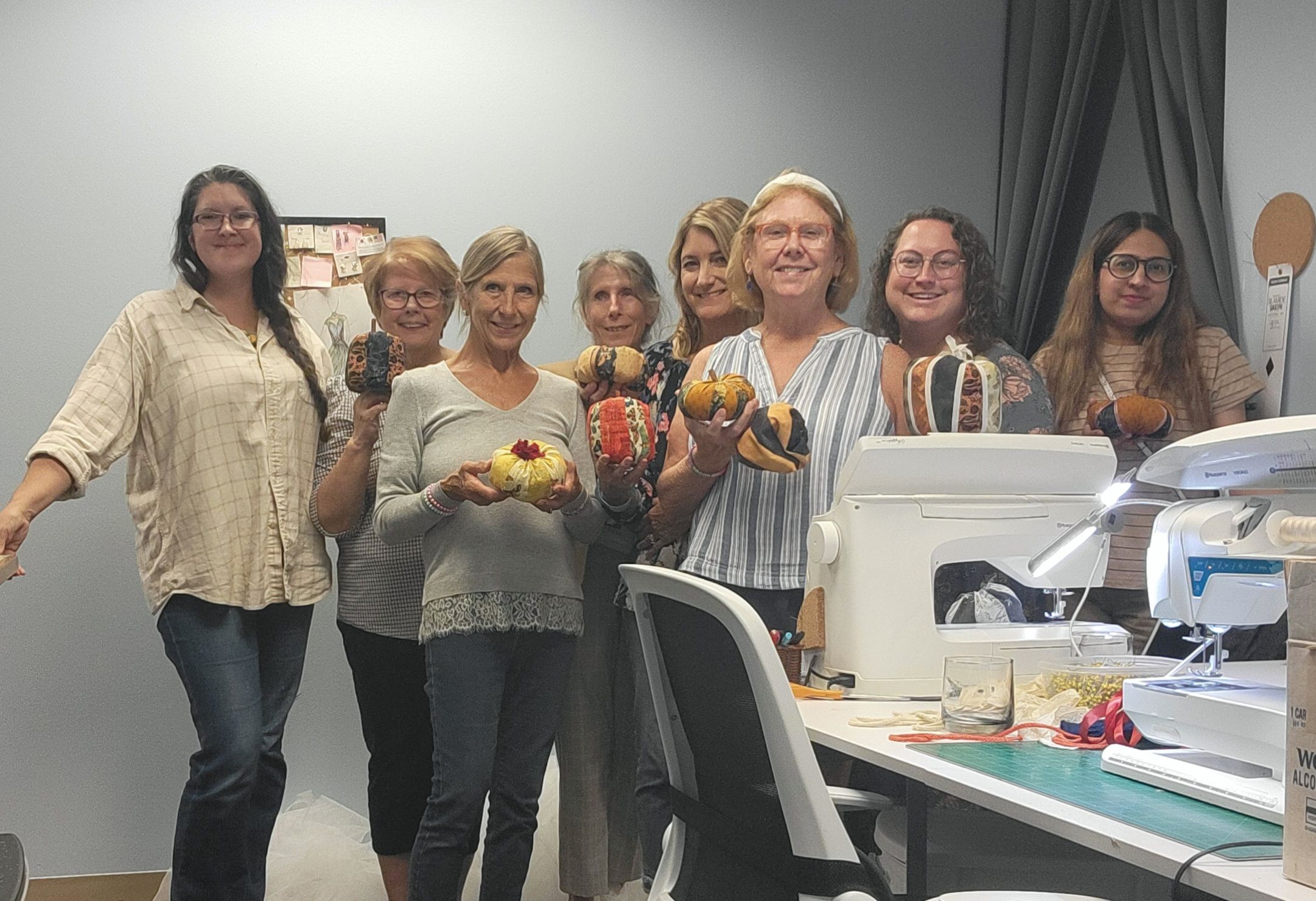 Sip-n-Sew workshop group with handmade fabric pumpkins