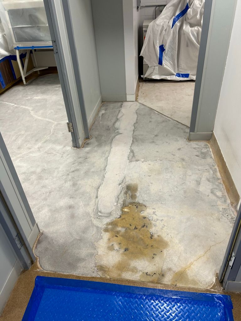 Before view of a worn pharmaceutical floor with staining and surface damage prior to epoxy restoration