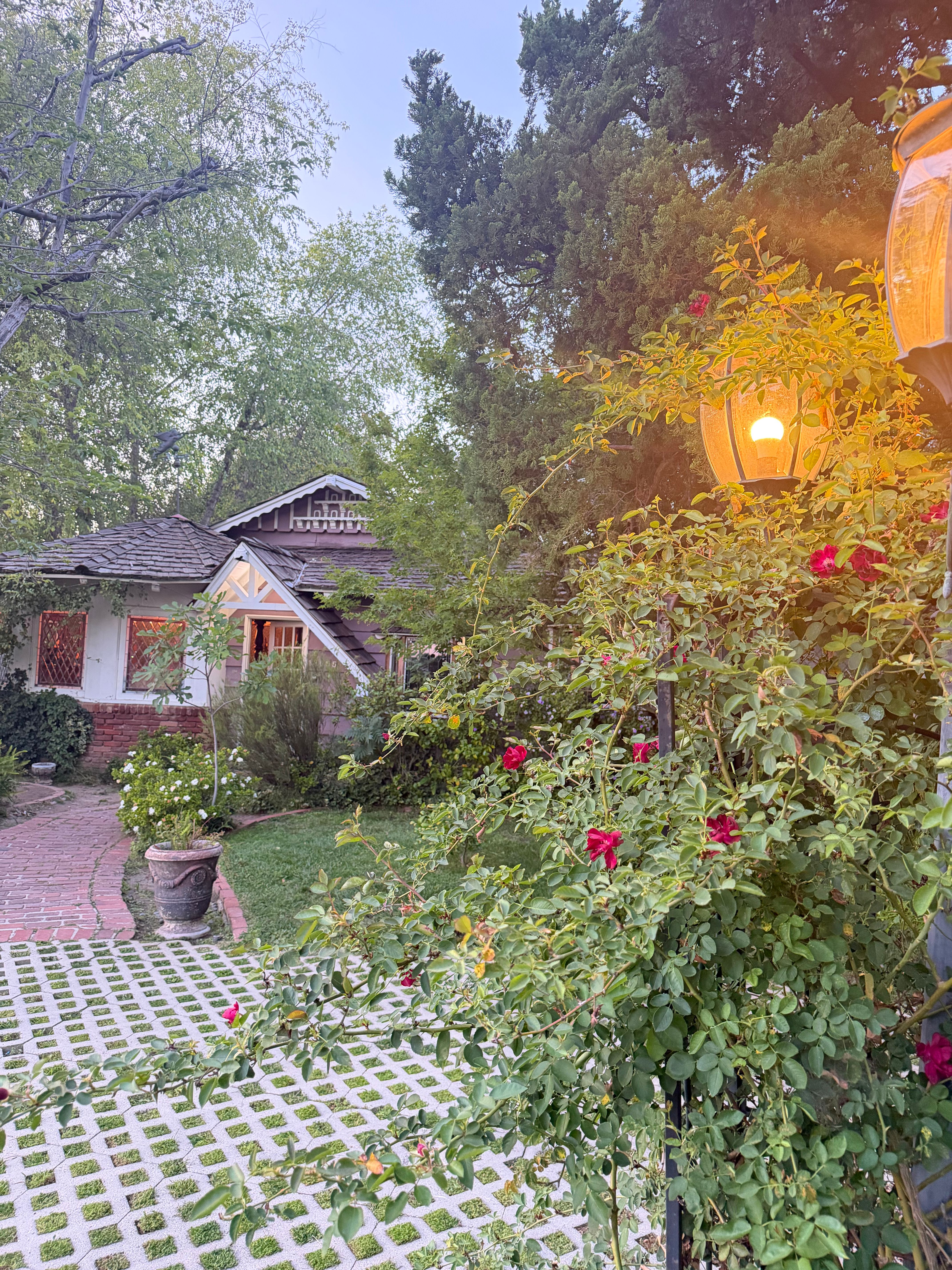 The Cottage at Sherwood Studios — brick pathway with rose lanterns