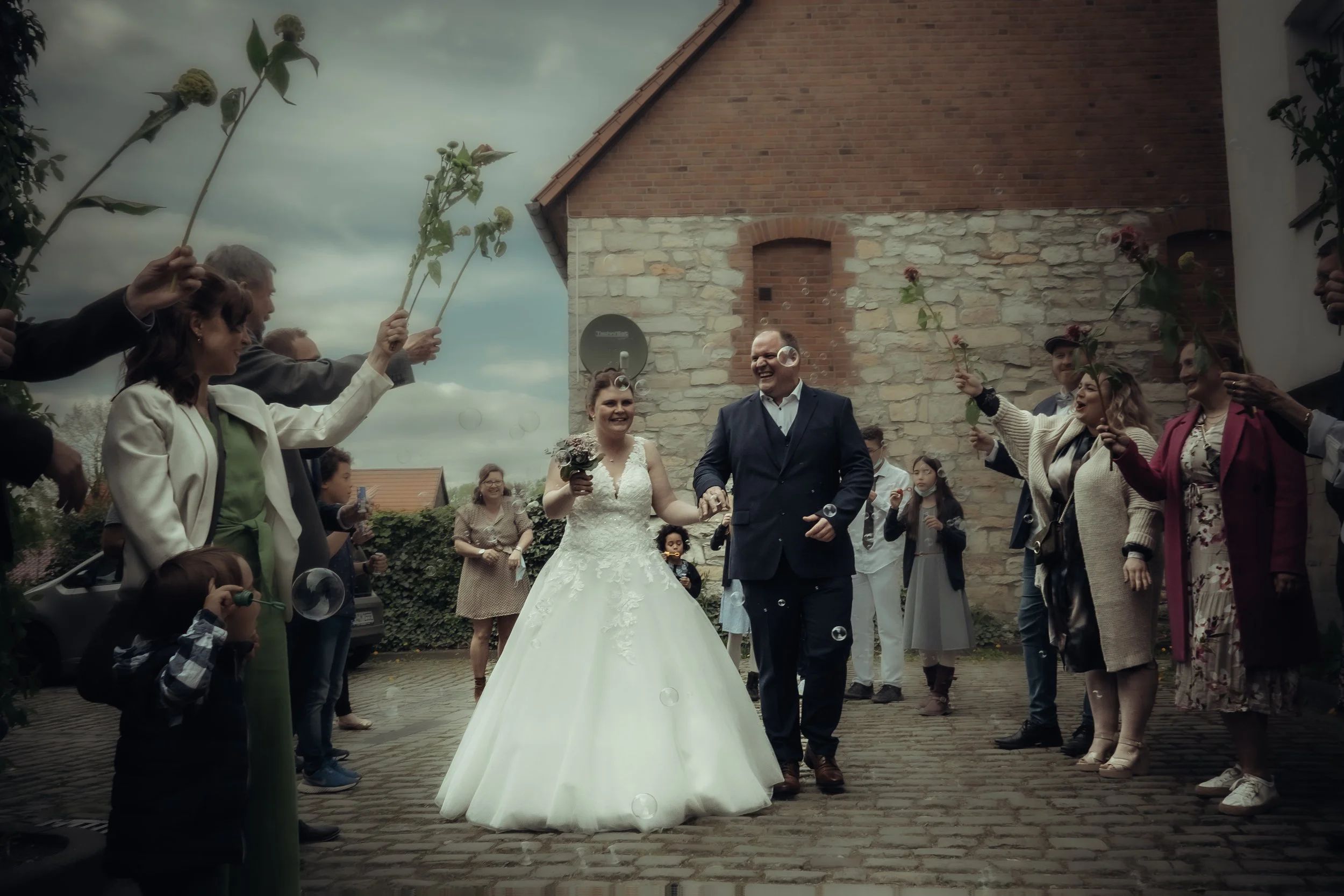 Intimate wedding moment between bride and groom surrounded by lush greenery in late summer, Bavaria