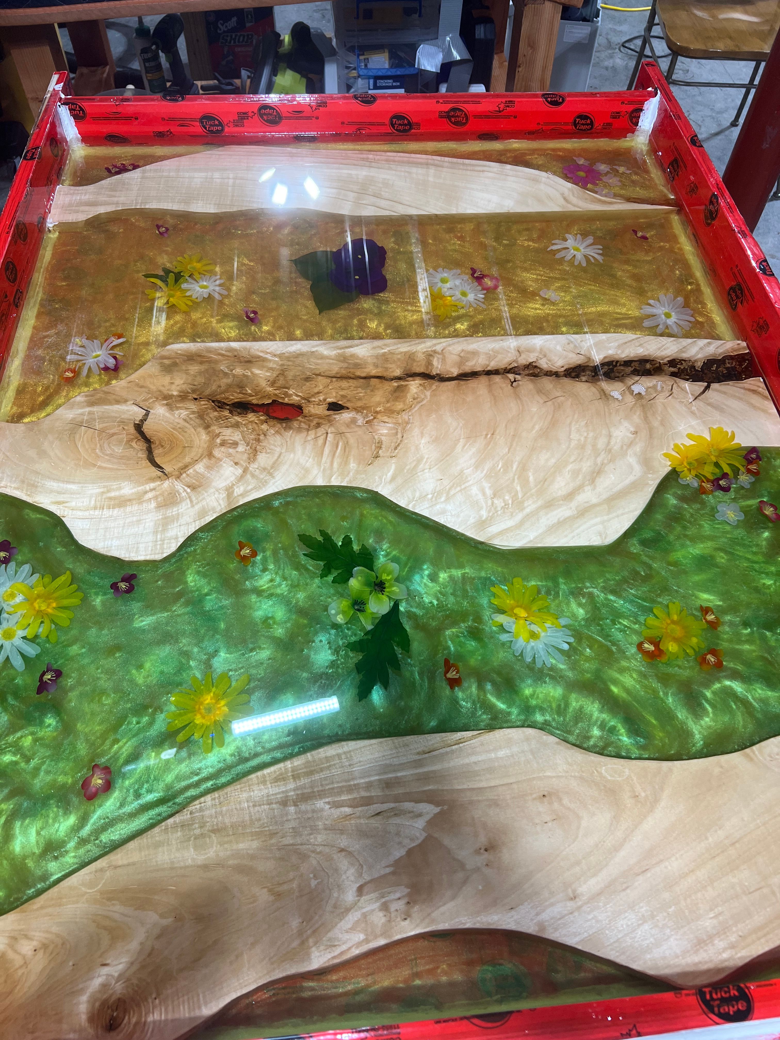 Wood and resin piece with embedded colorful flowers