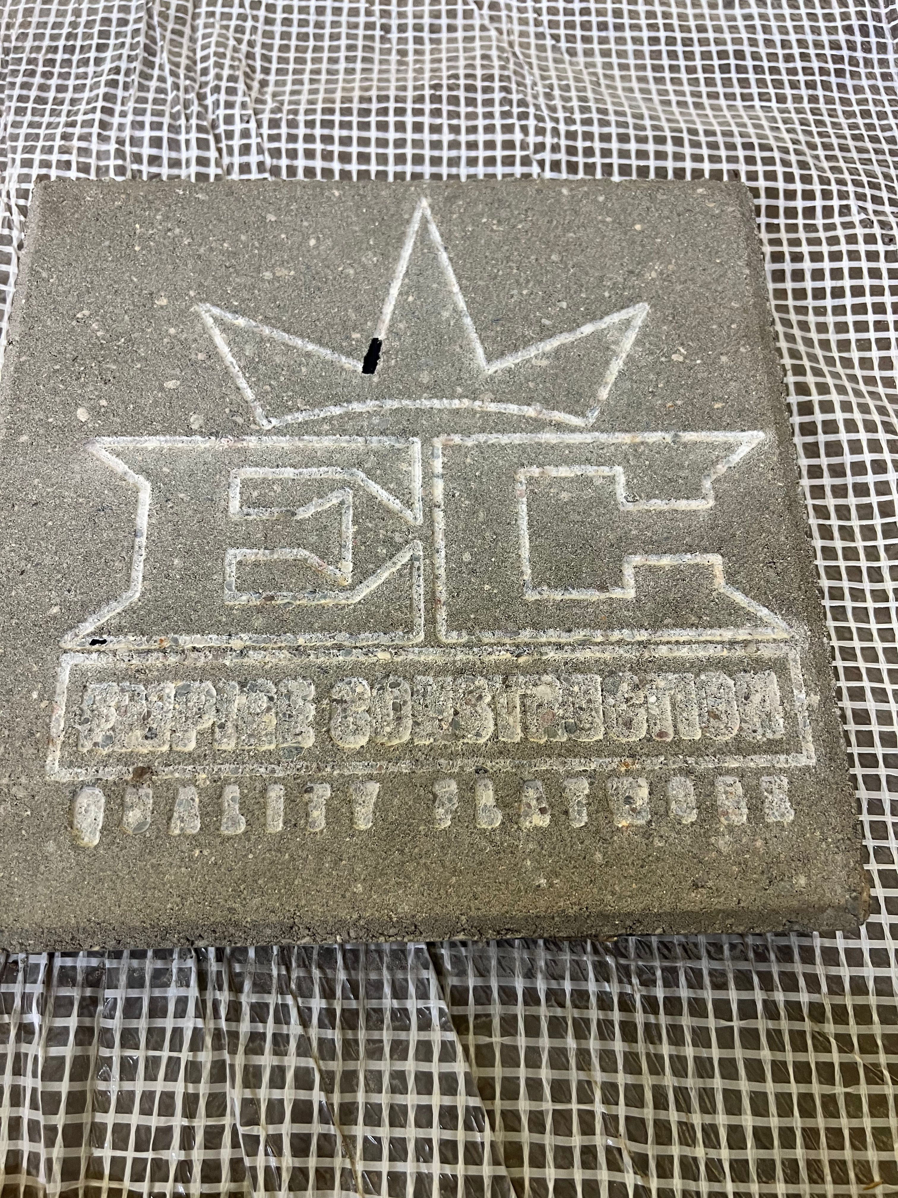 Empire Construction logo engraved in concrete slab