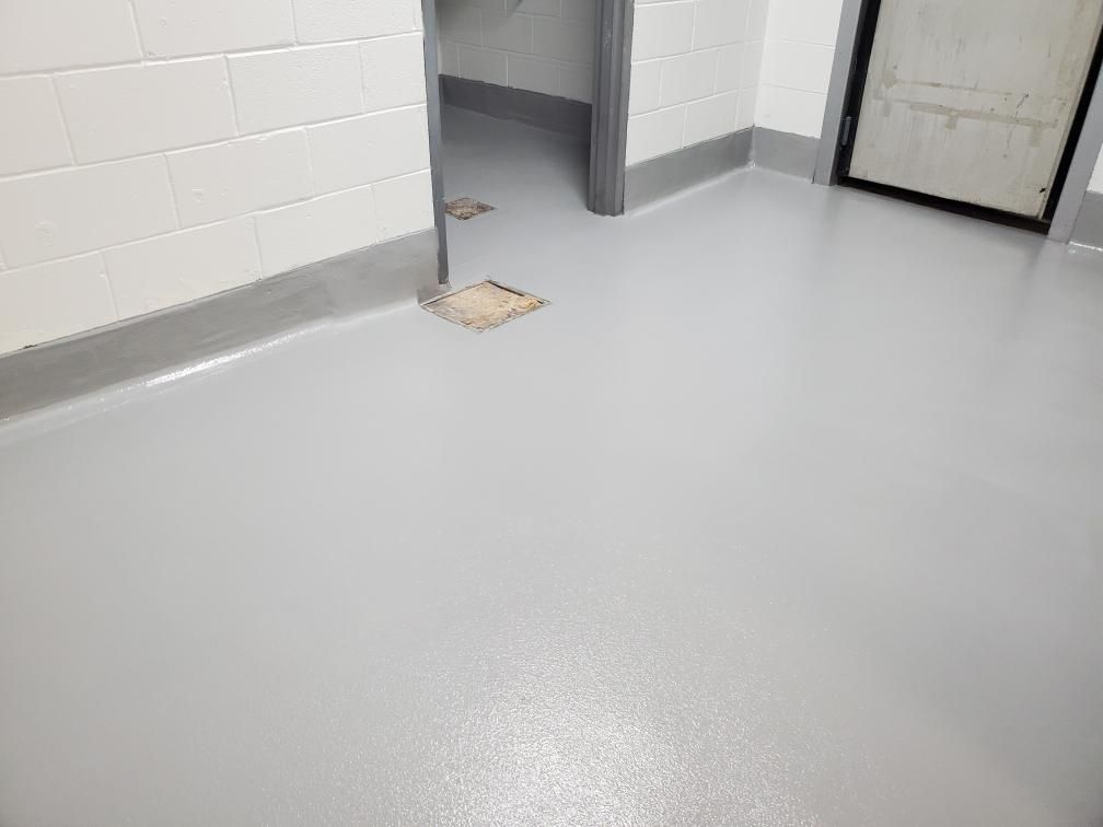 Seamless gray epoxy flooring with coved base in food and beverage facility room