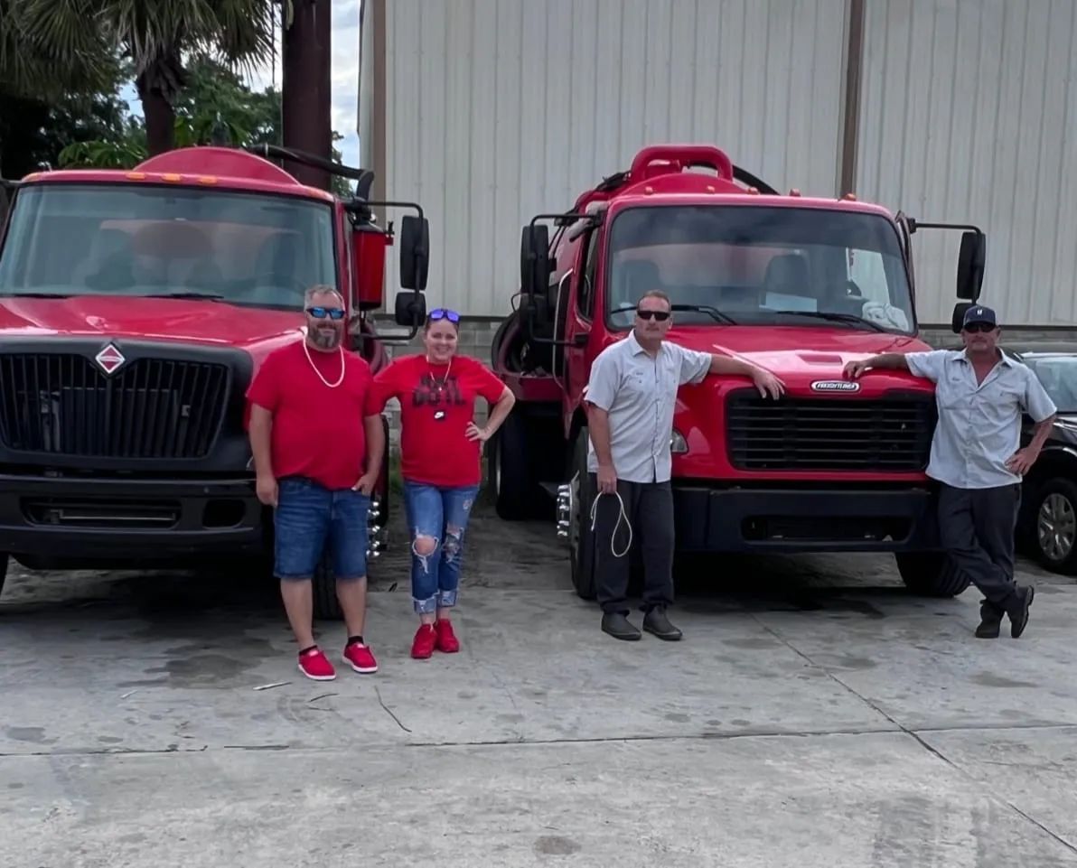 All About Septic Services team standing in front of service trucks