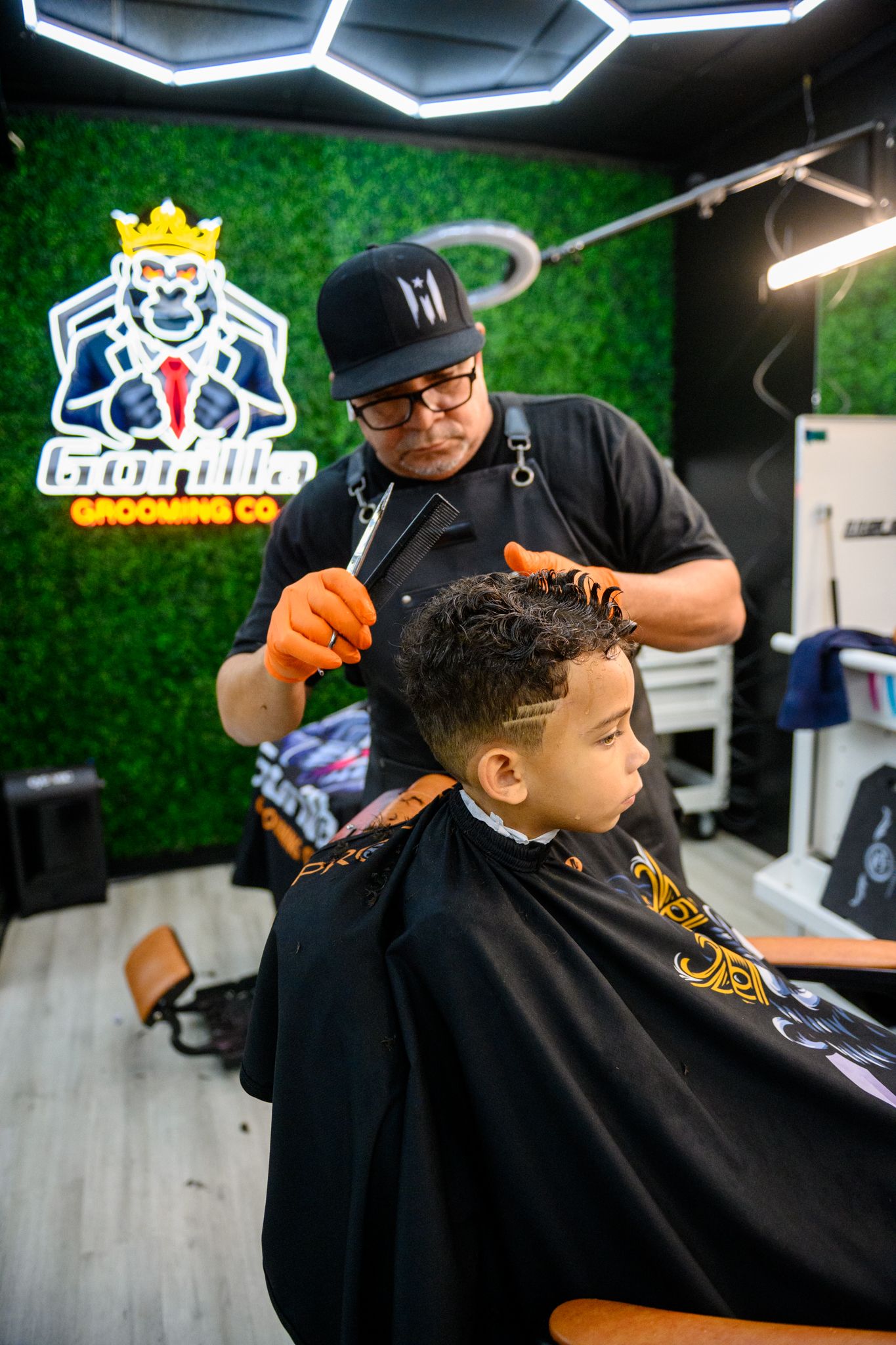 Barber cutting a kid's hair with scissors