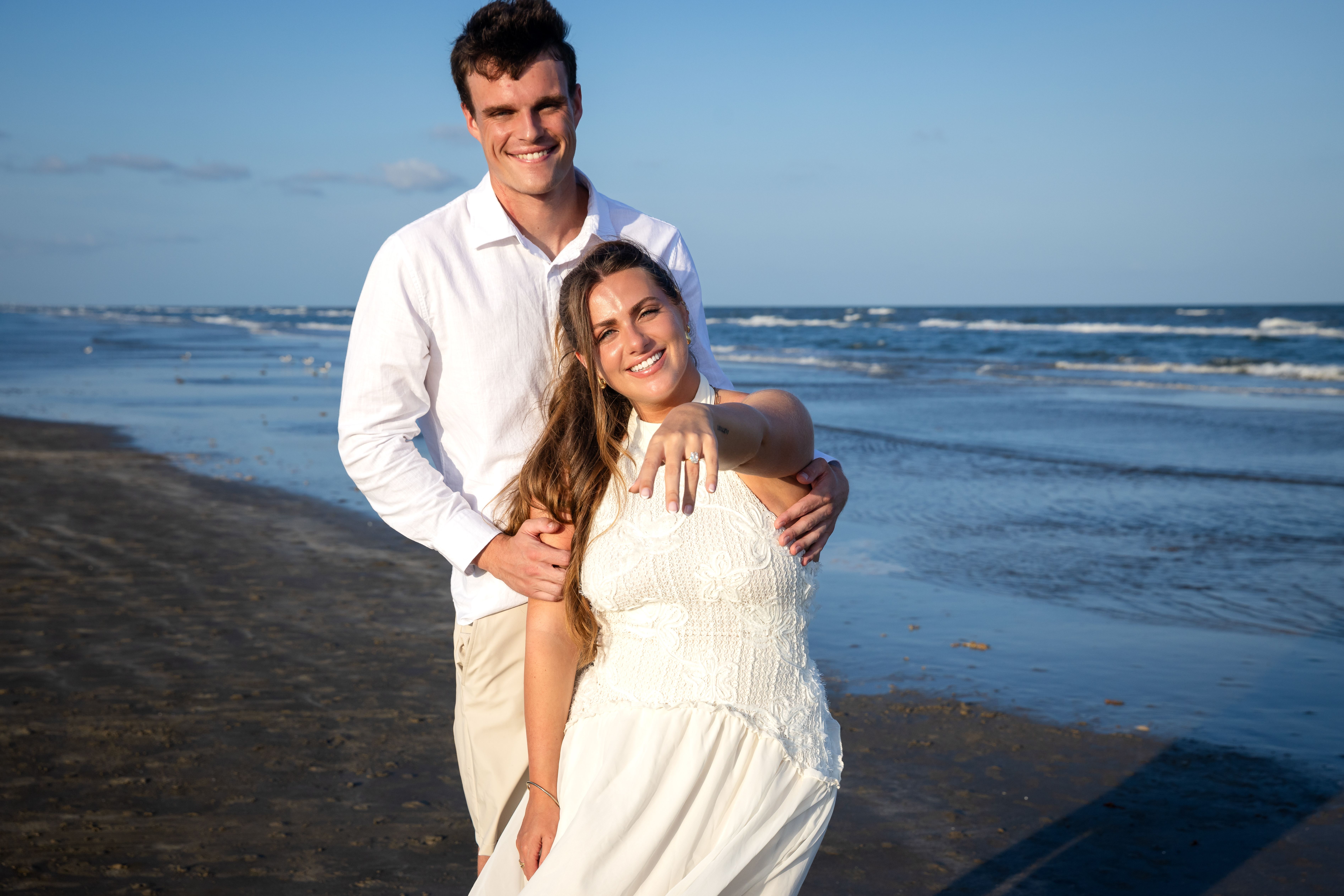 Couple smiling together on the wet sand