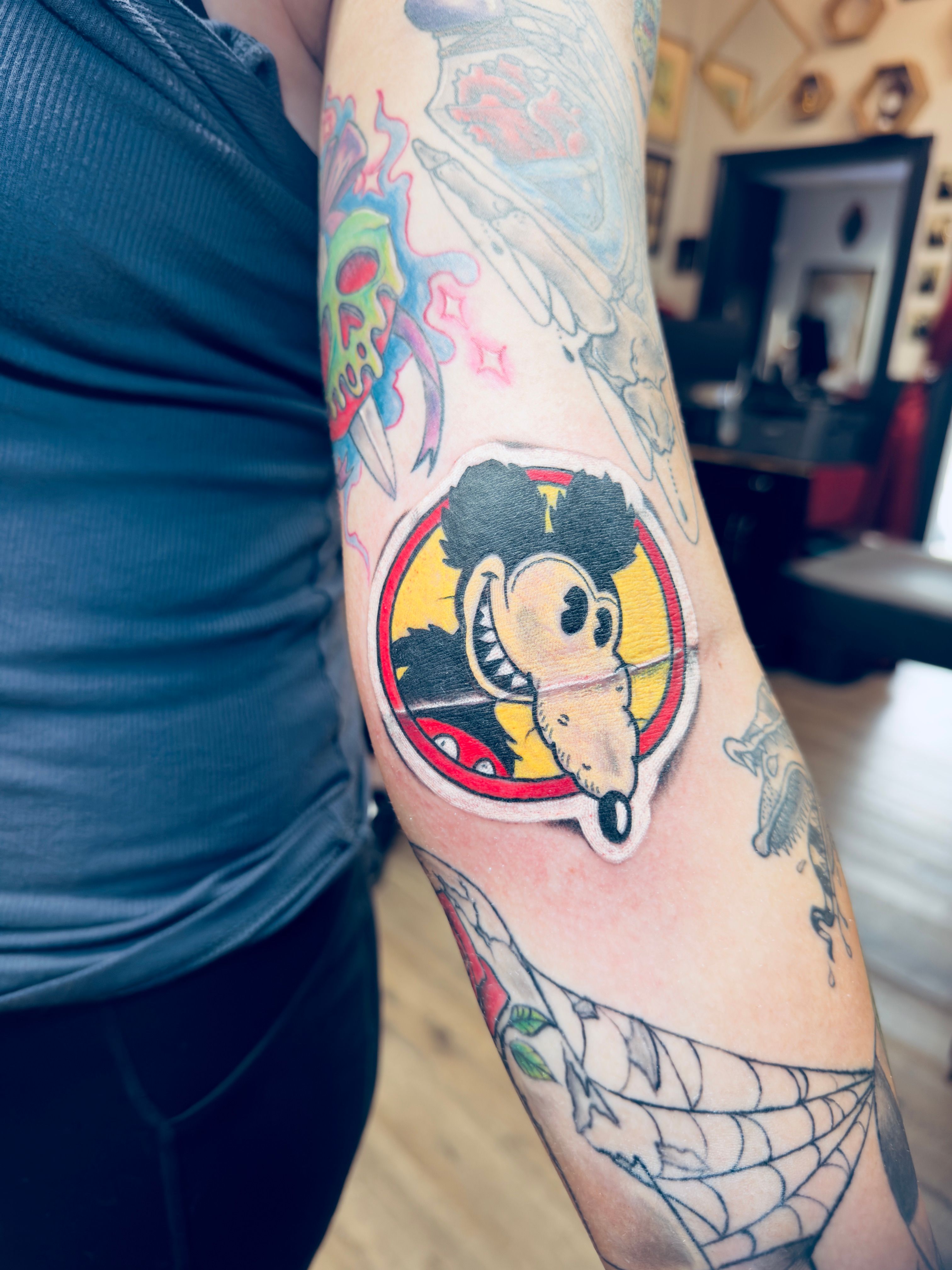 Color tattoo by Justin - cartoon character portrait with circular background