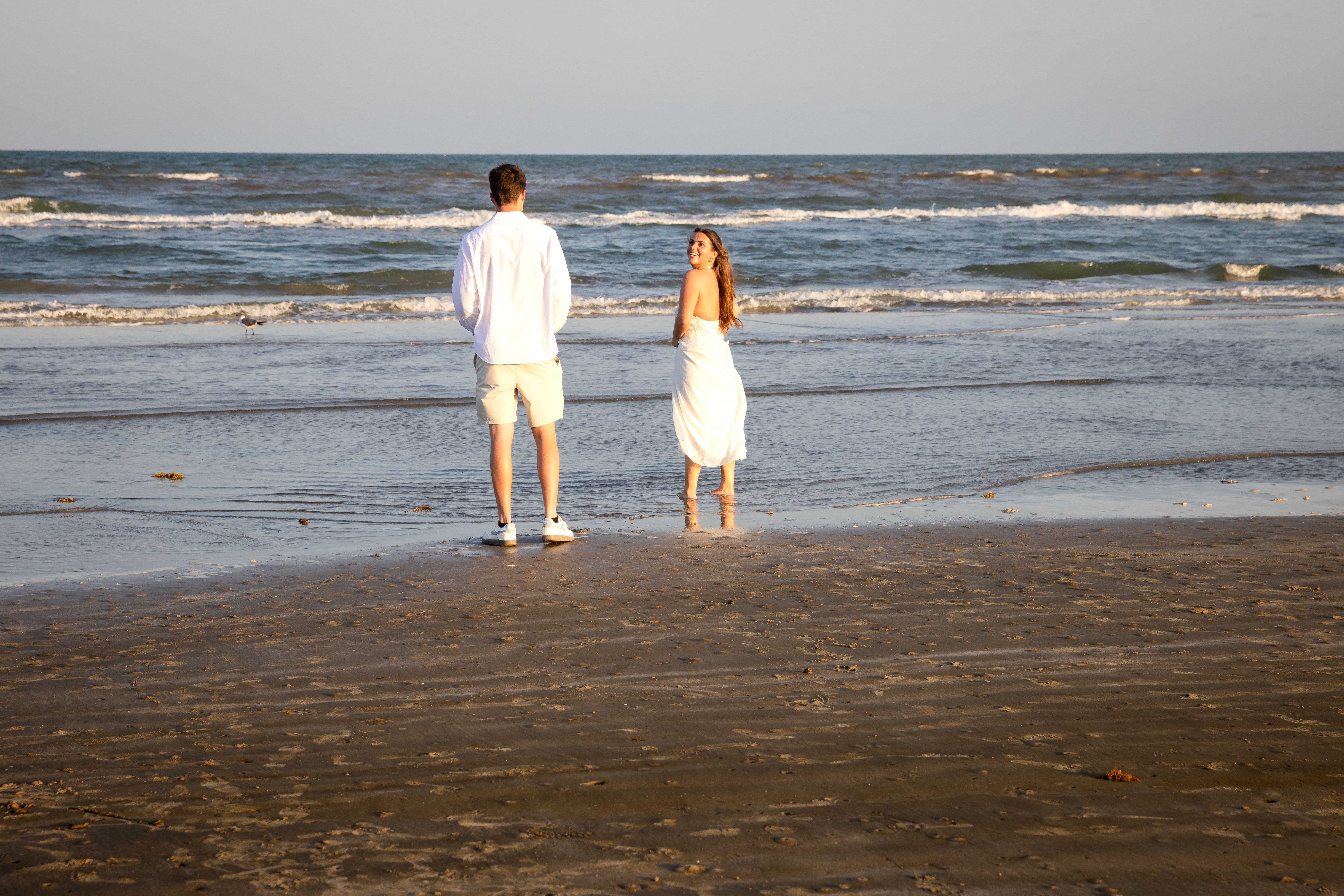 Couple facing the ocean together