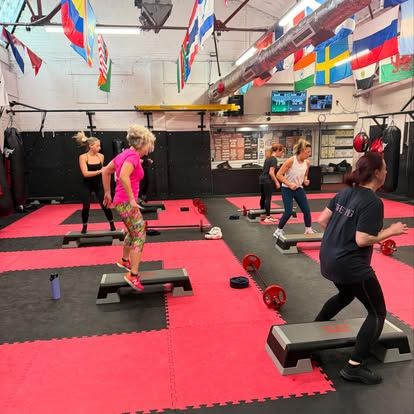 Women's fitness class with step platforms