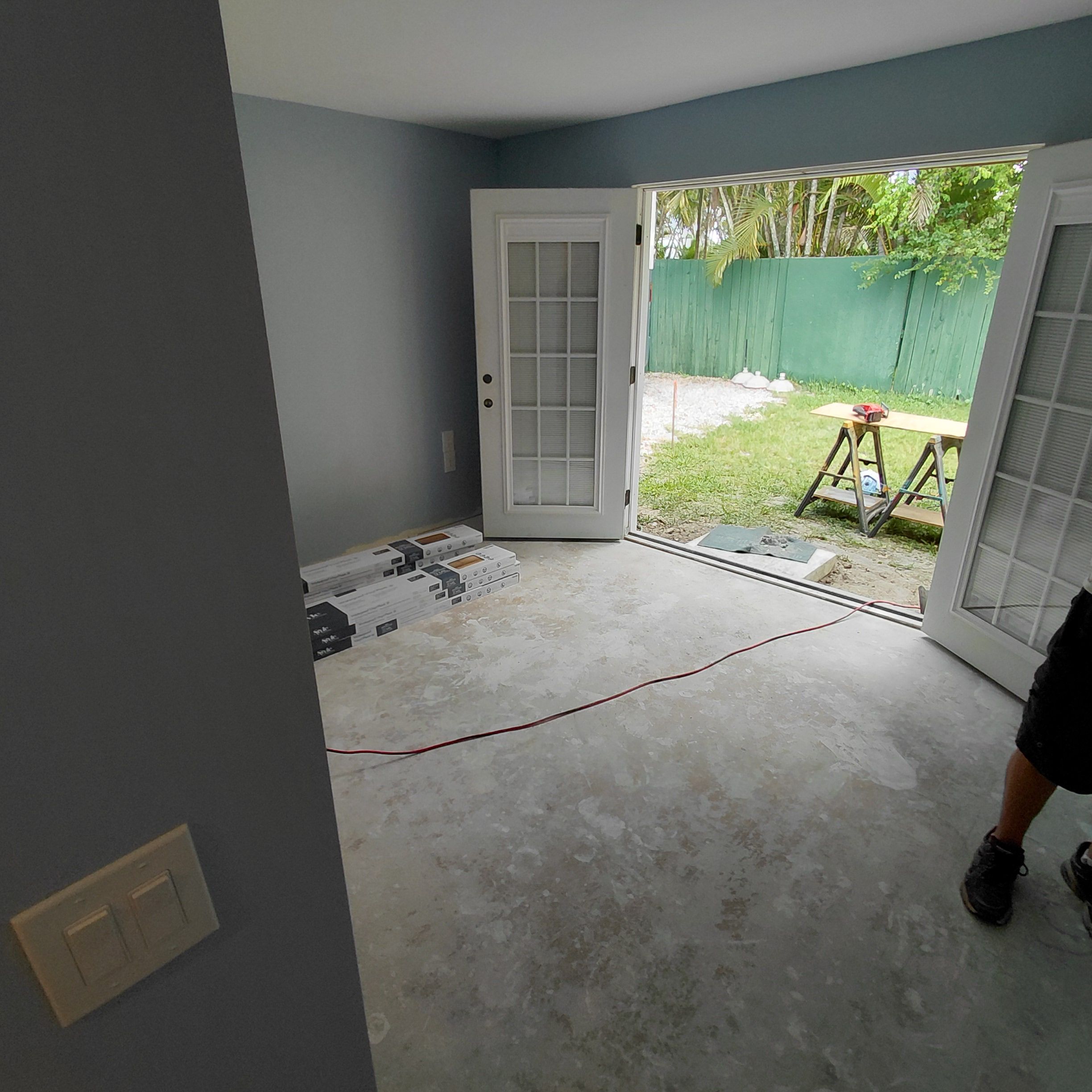 French doors opening to a backyard during a renovation