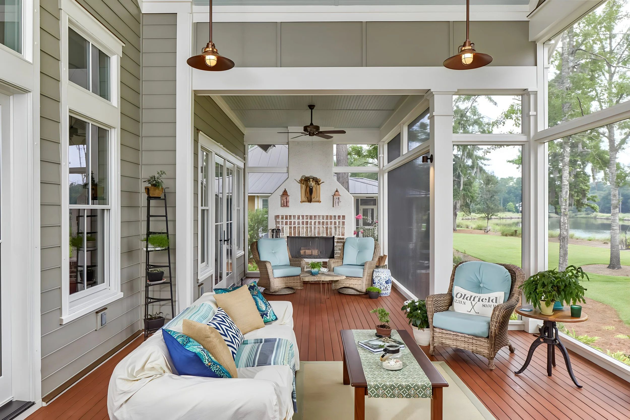 Luxury screened porch with fireplace and waterfront view in Charleston Lowcountry