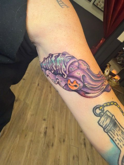 Color tattoo by Justin - purple squid cover-up on forearm