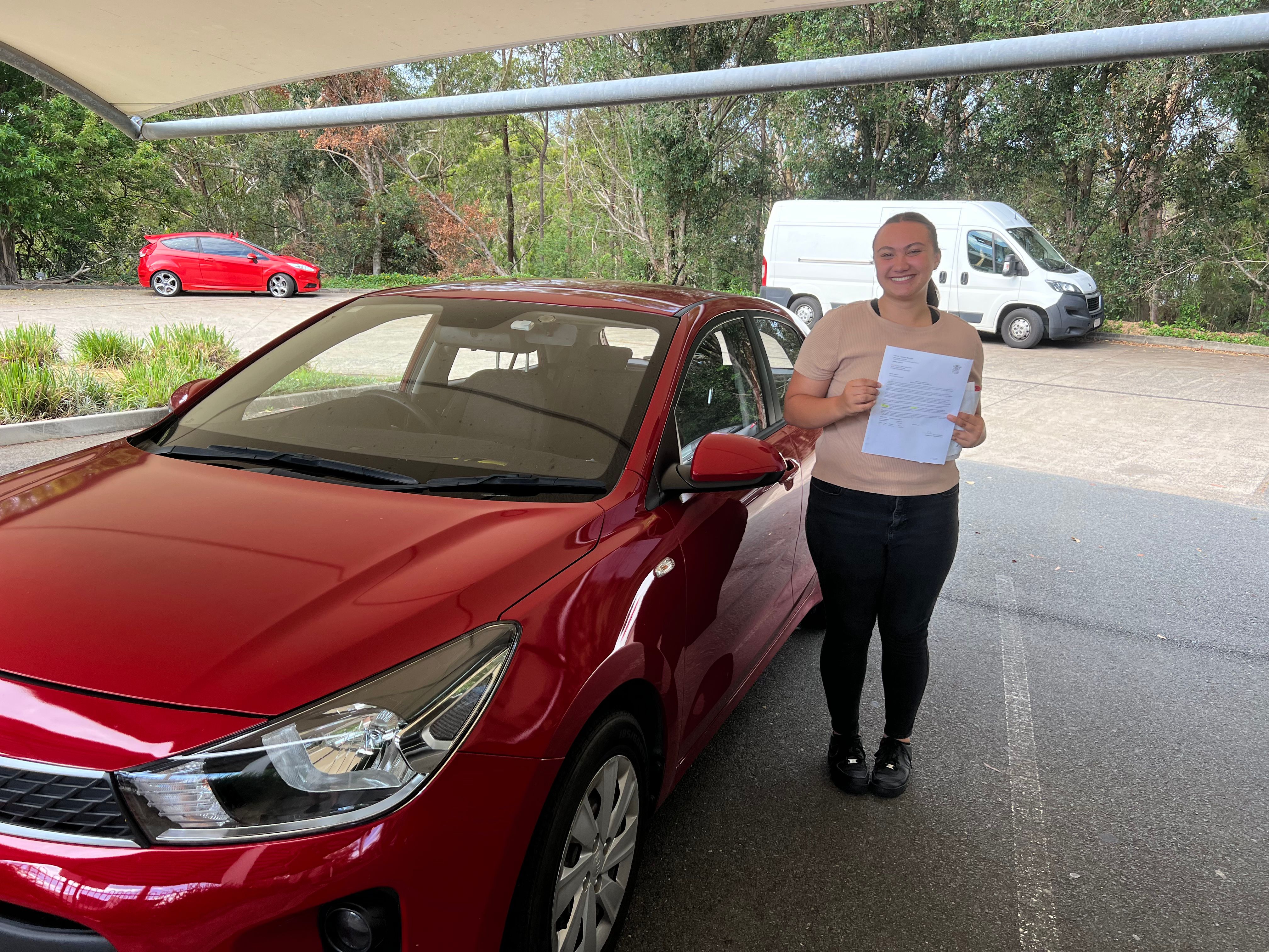 Happy learner driver smiling after completing driving lessons in Helensvale Gold Coast with RED Driver Training