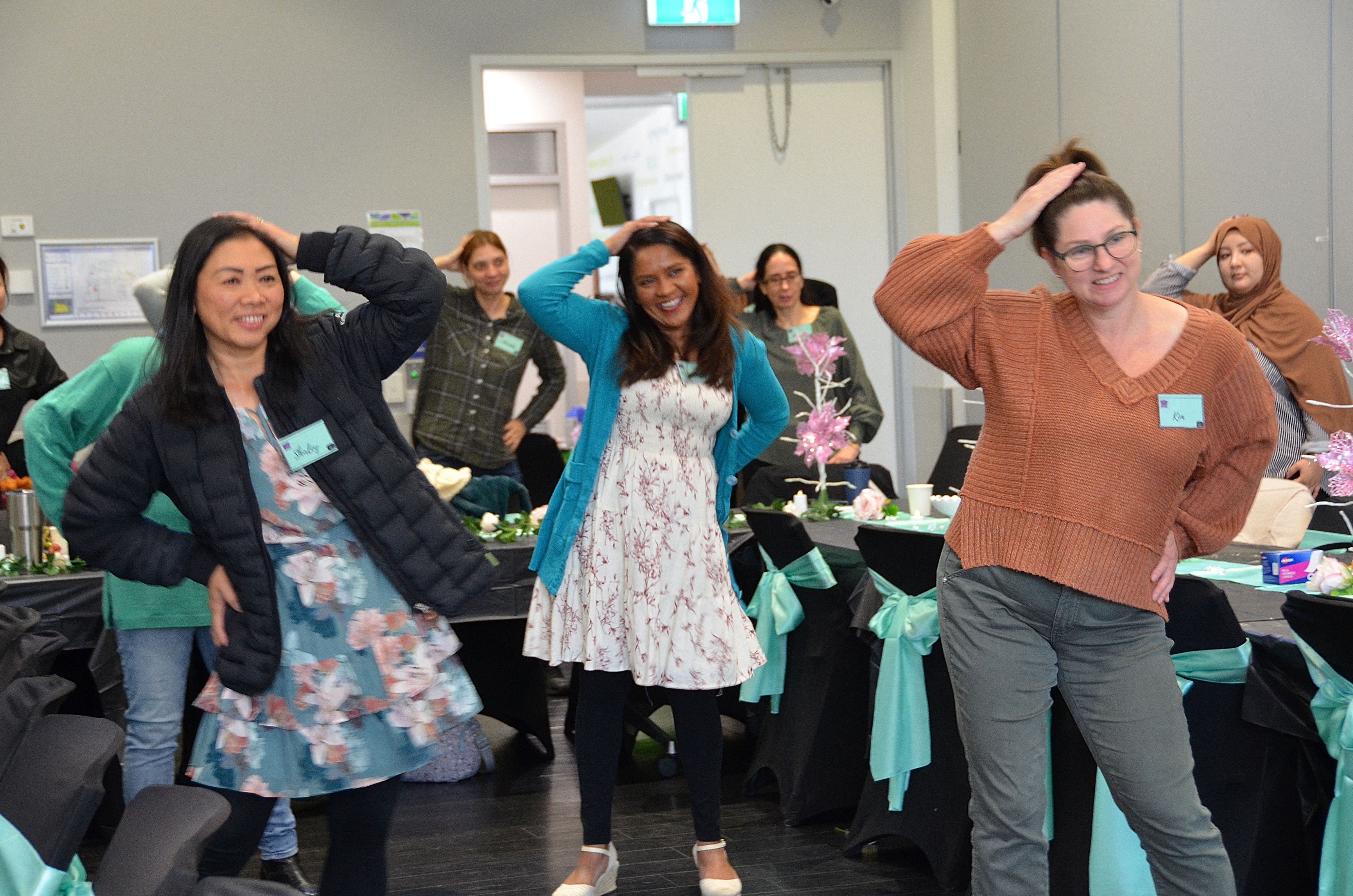 Women doing a fun group pose at E-Girl Empowerment workshop in Melbourne