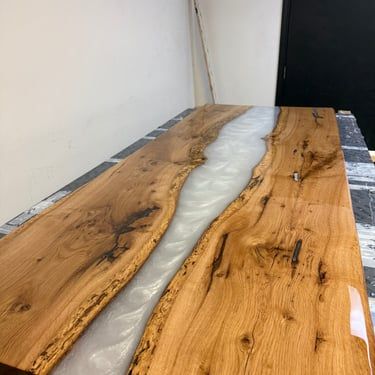 Epoxy river table with milky white resin and natural wood grain by Bark and Brushes