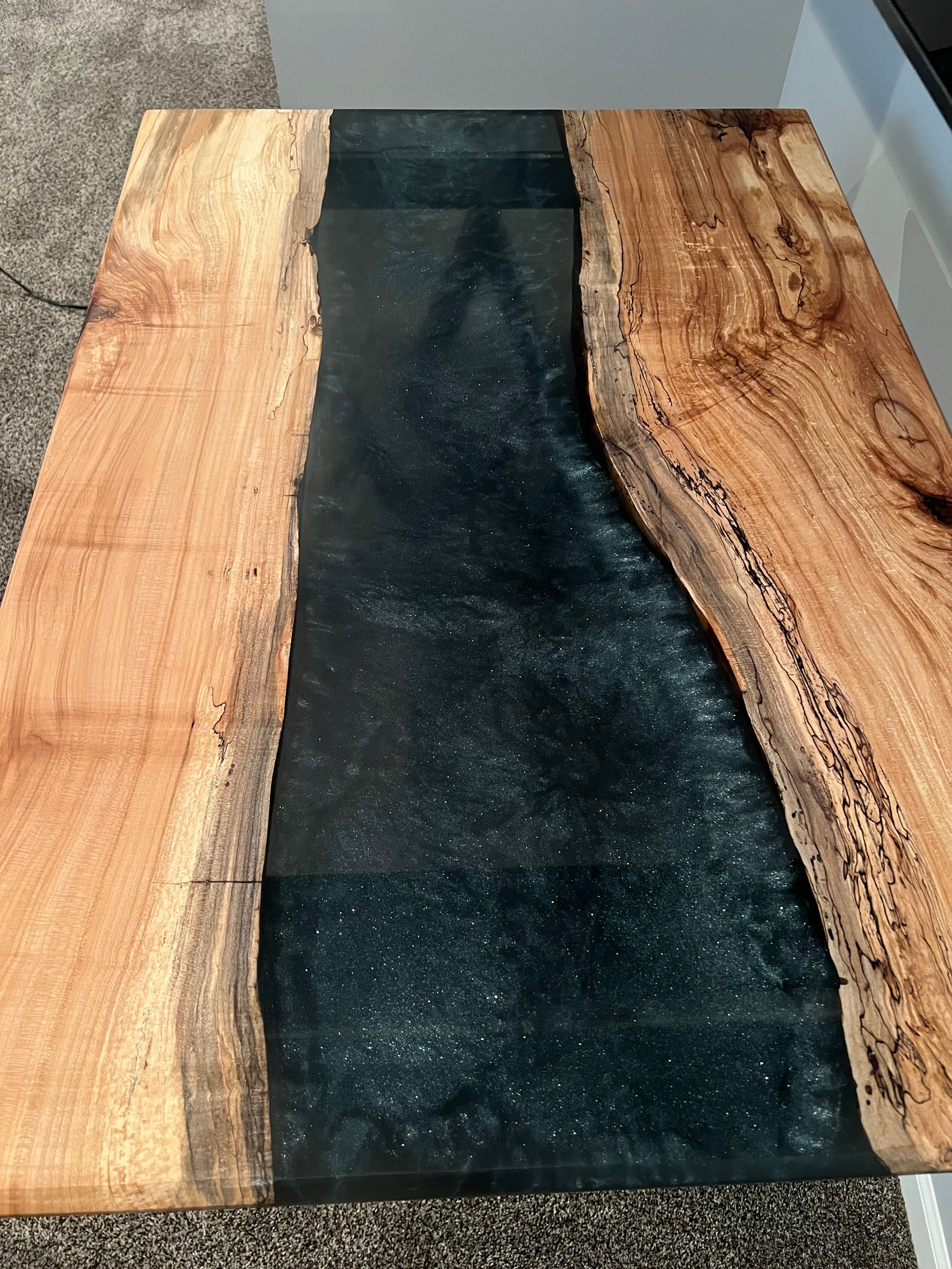 Black resin river table top with natural wood grain