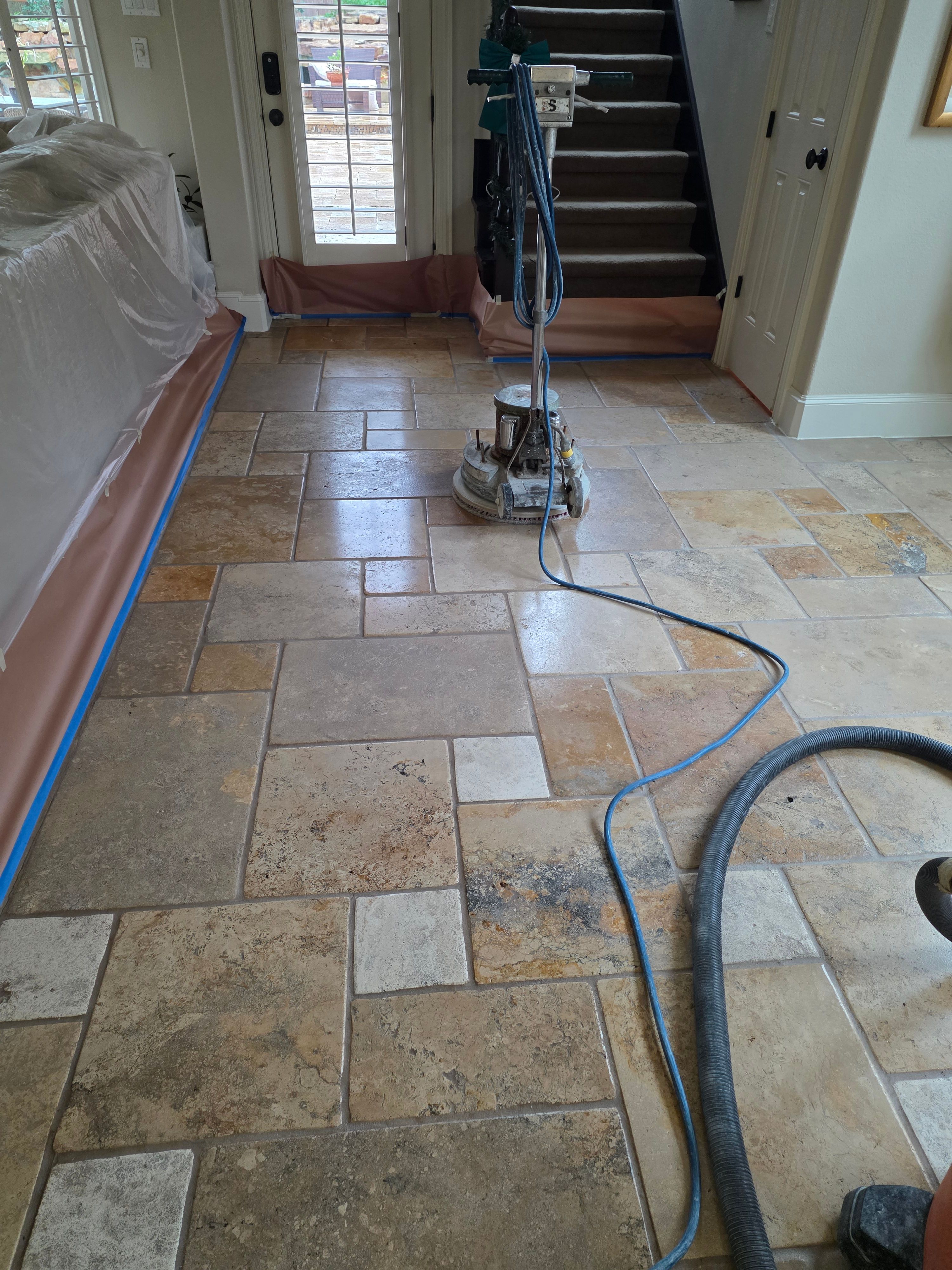 Travertine floor during professional polishing process