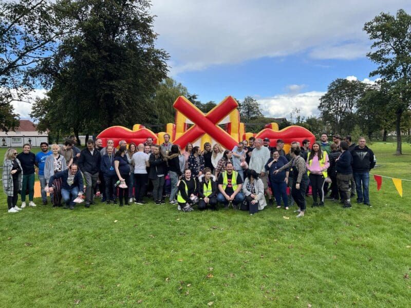 Large outdoor corporate fun day with families enjoying giant Connect Four and activities organised by Event Collection