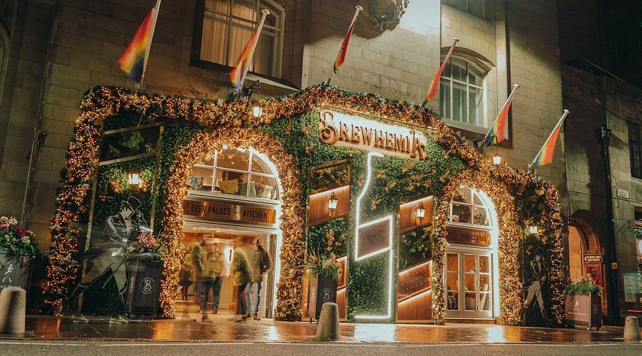 Brewhemia exterior in Edinburgh Old Town — Scotland's Beer Palace with ornate archway lighting, greenery and vibrant atmosphere, corporate event and evening entertainment venue