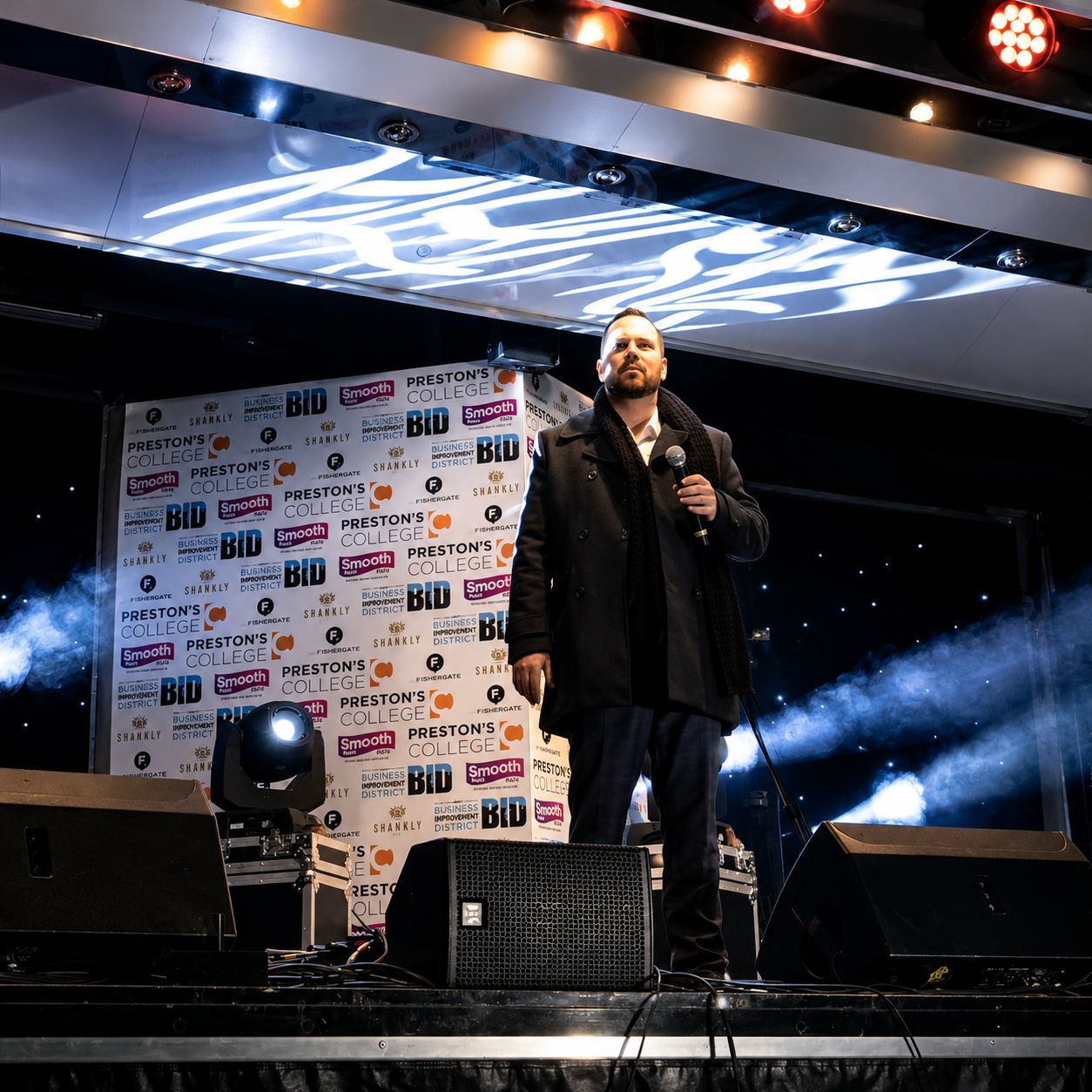 Ryan Wallace — The Opera Guy performing on a professional stage with dramatic lighting and smoke effects