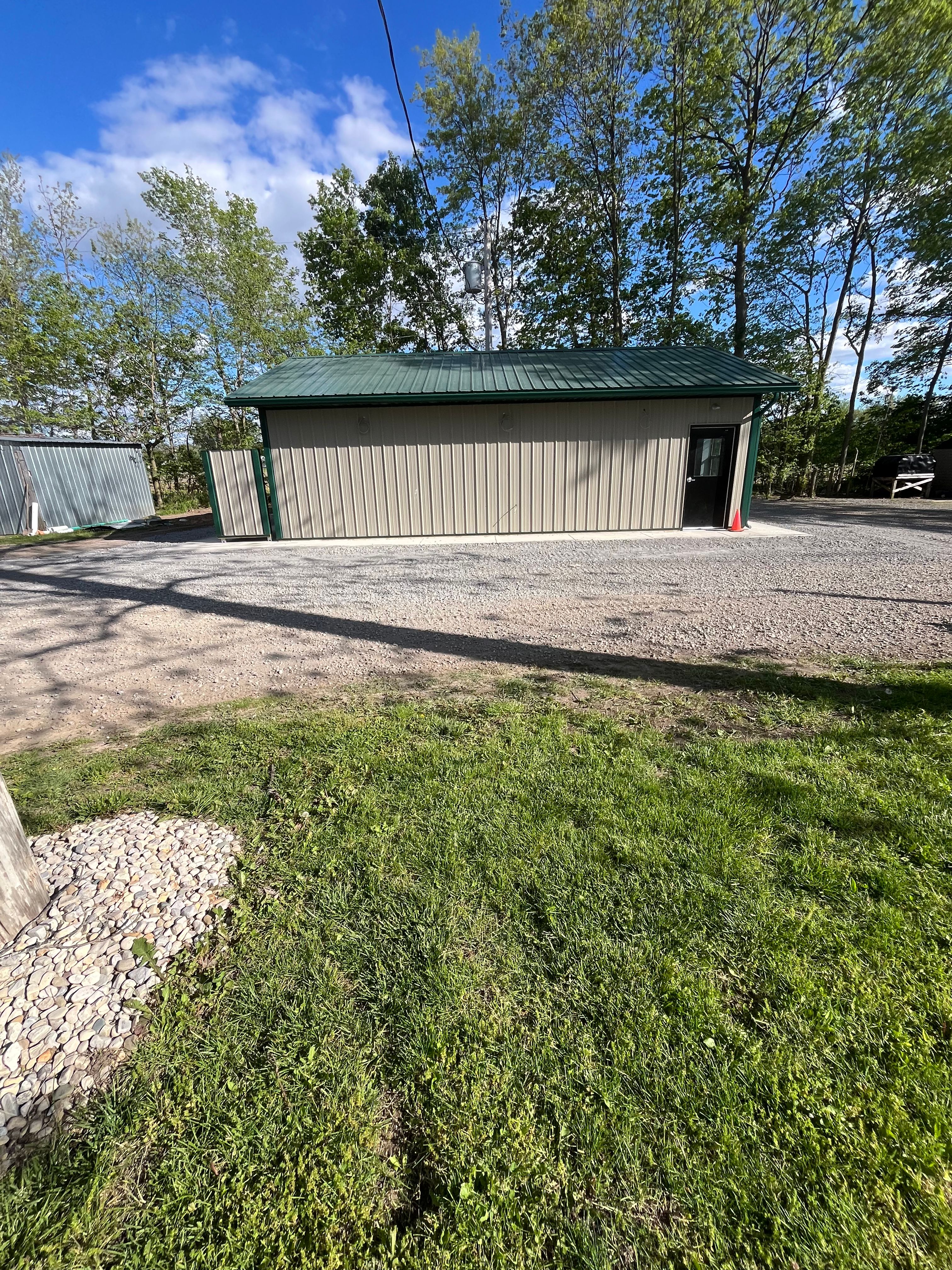 New Welcome Woods facility building with green roof and black door
