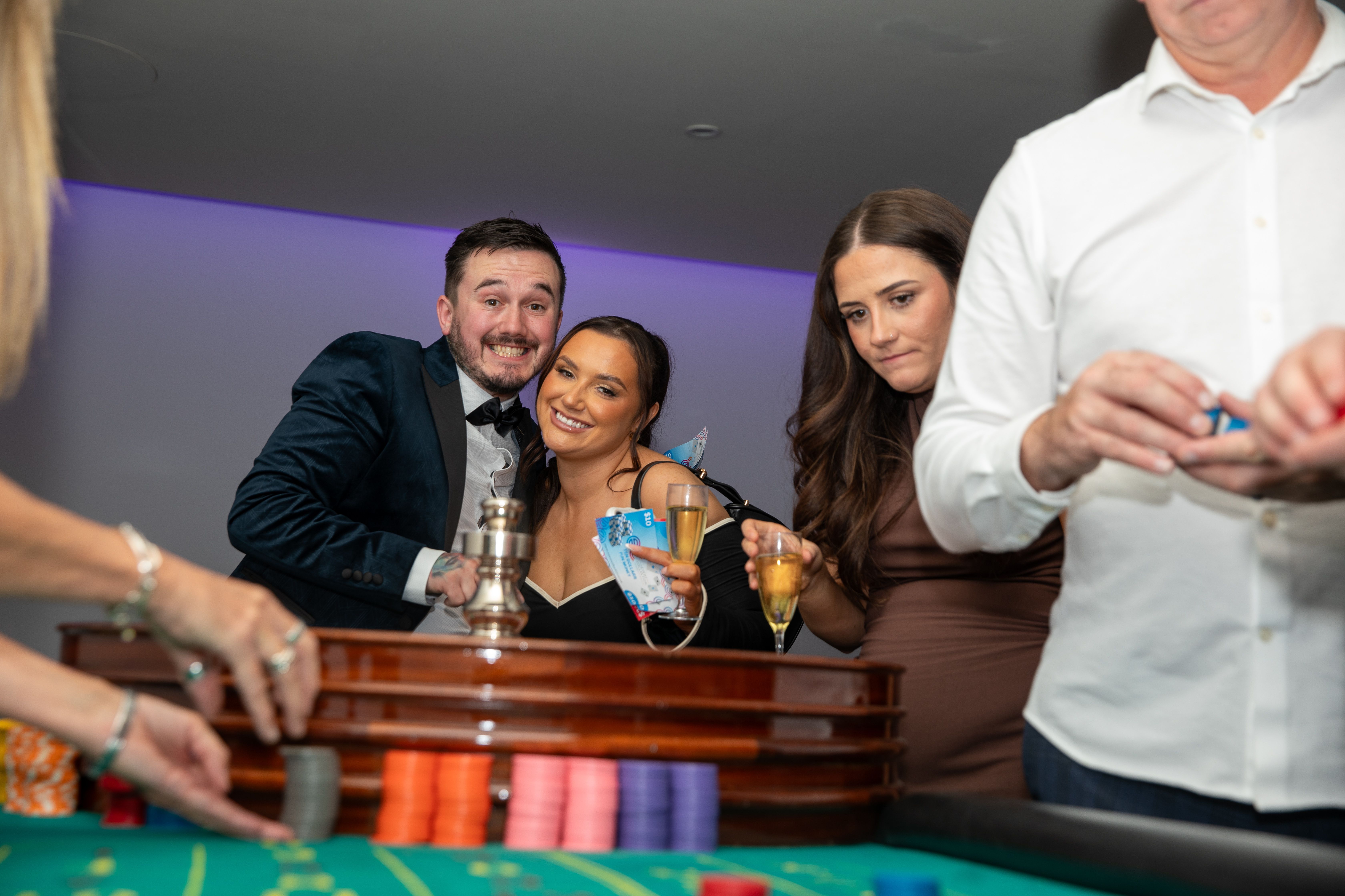 Evening entertainment corporate event — guests enjoying a casino-style evening with champagne and fun money chips by Event Collection