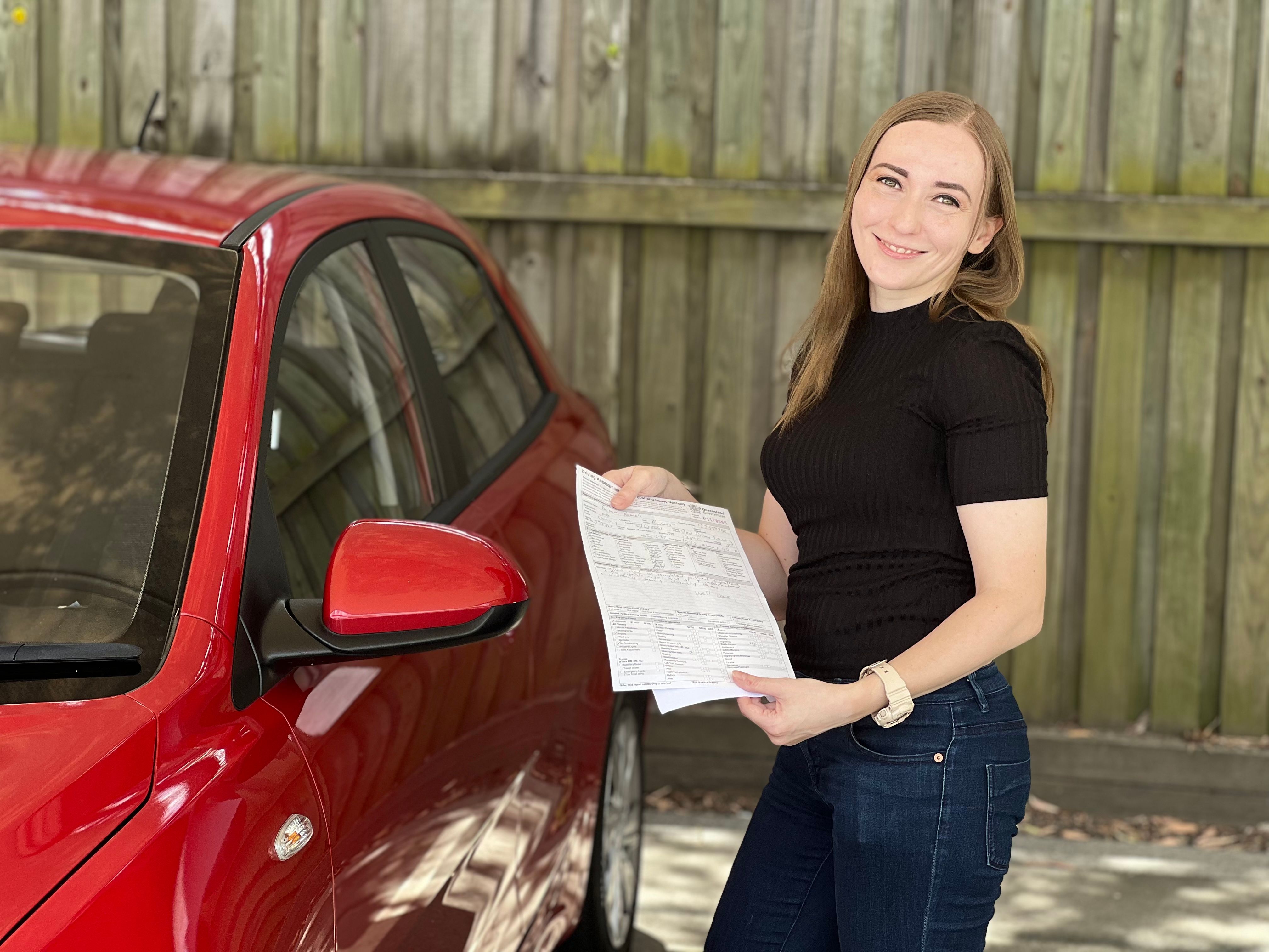 Happy graduate of RED Driver Training celebrating first-time pass on Gold Coast driving test