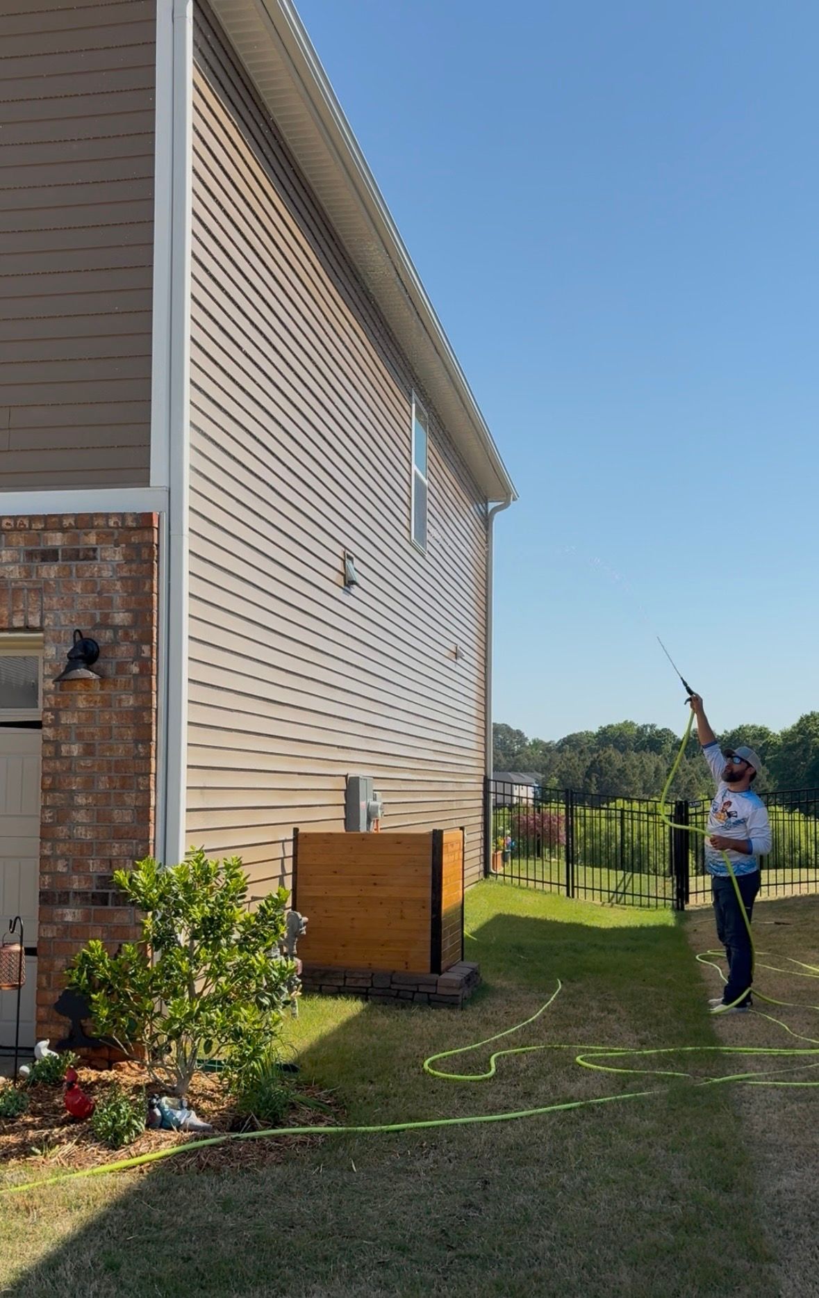Christopher pressure washing a home exterior in Rock Hill SC