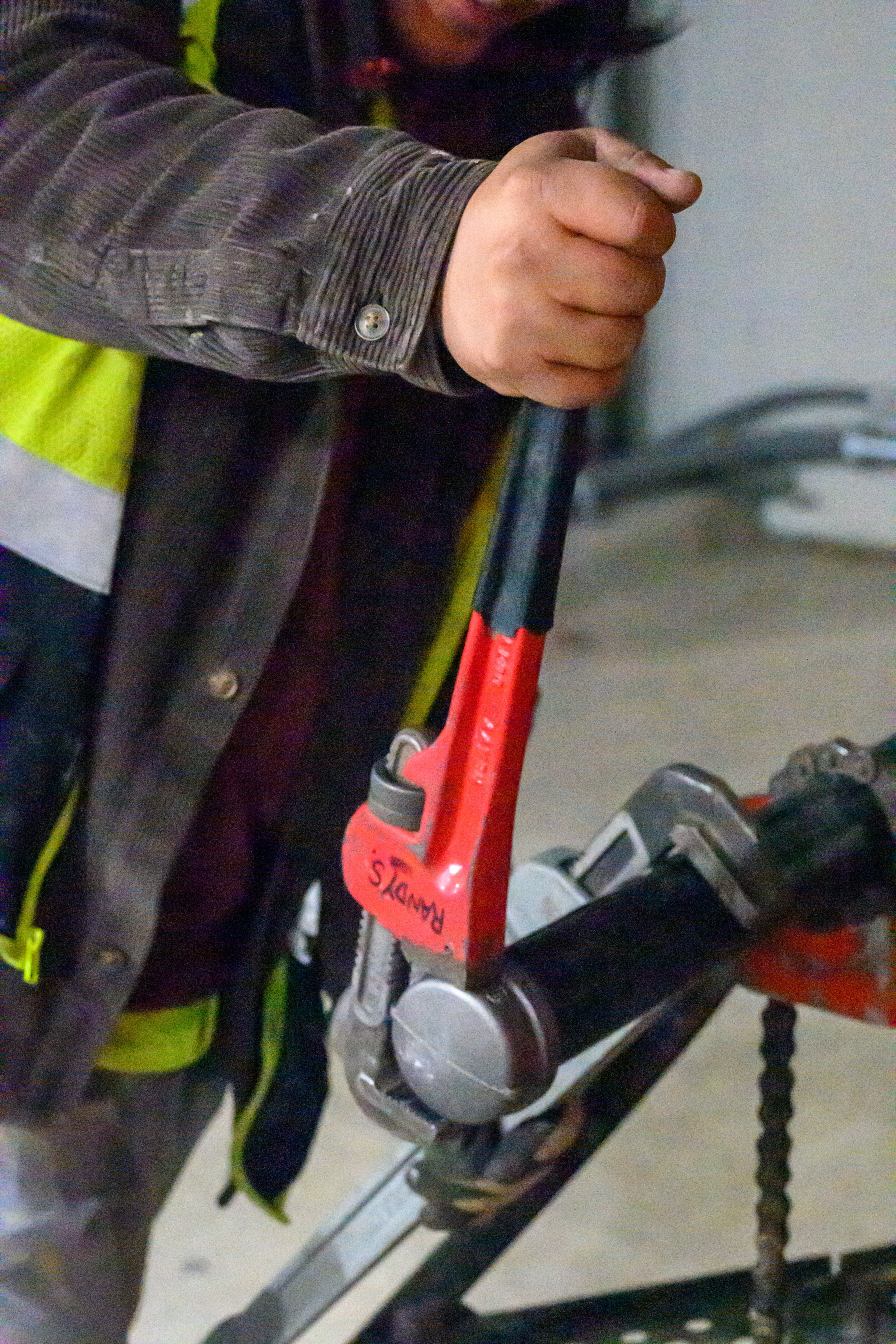 Pipe wrench being used on plumbing installation